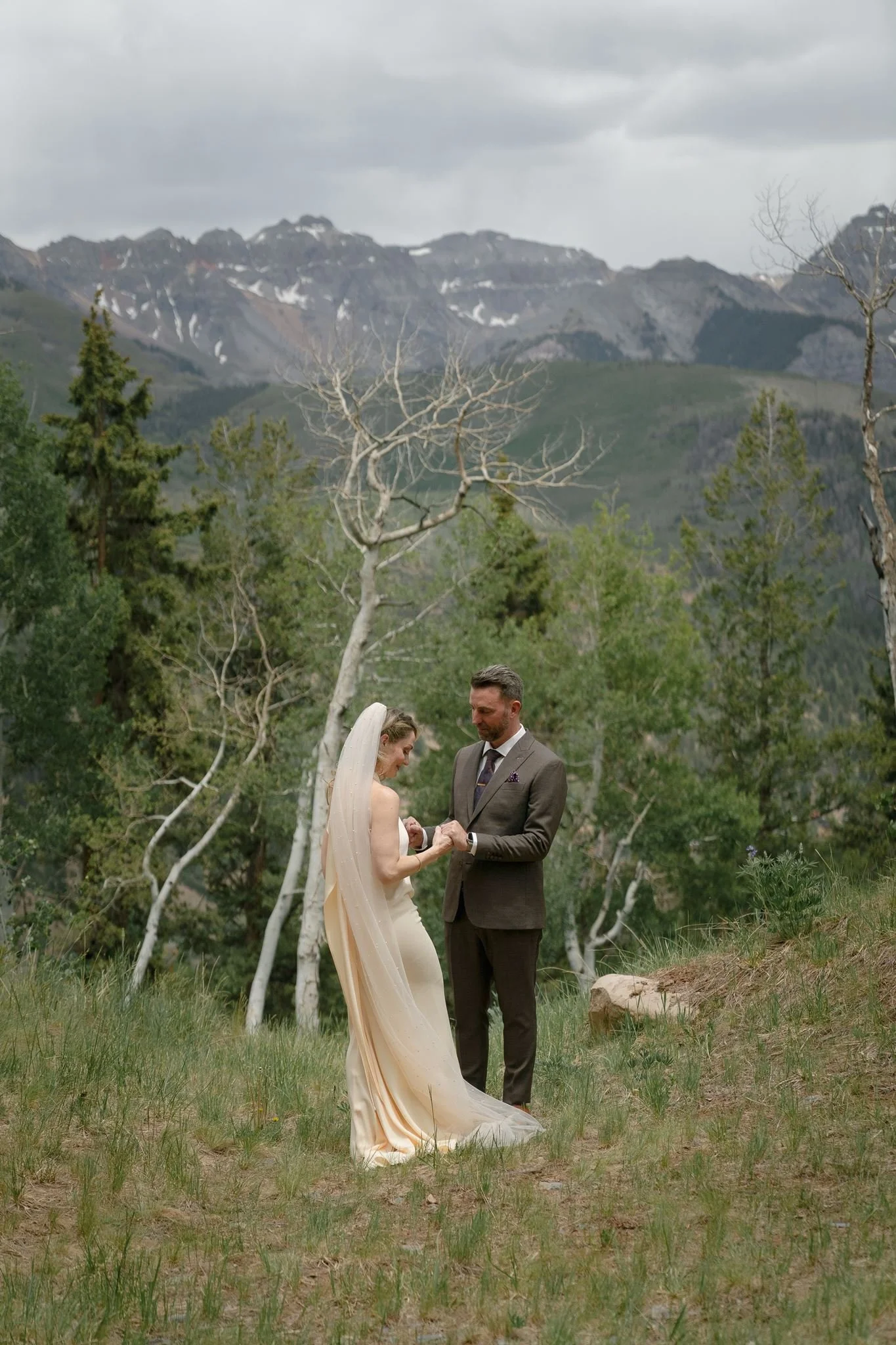 bride admires her groom's suit