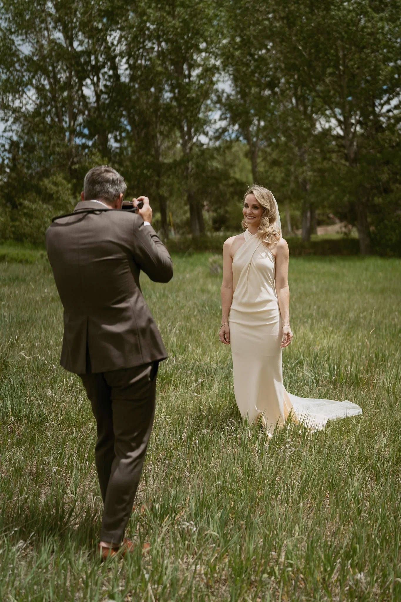 groom photographing his bride