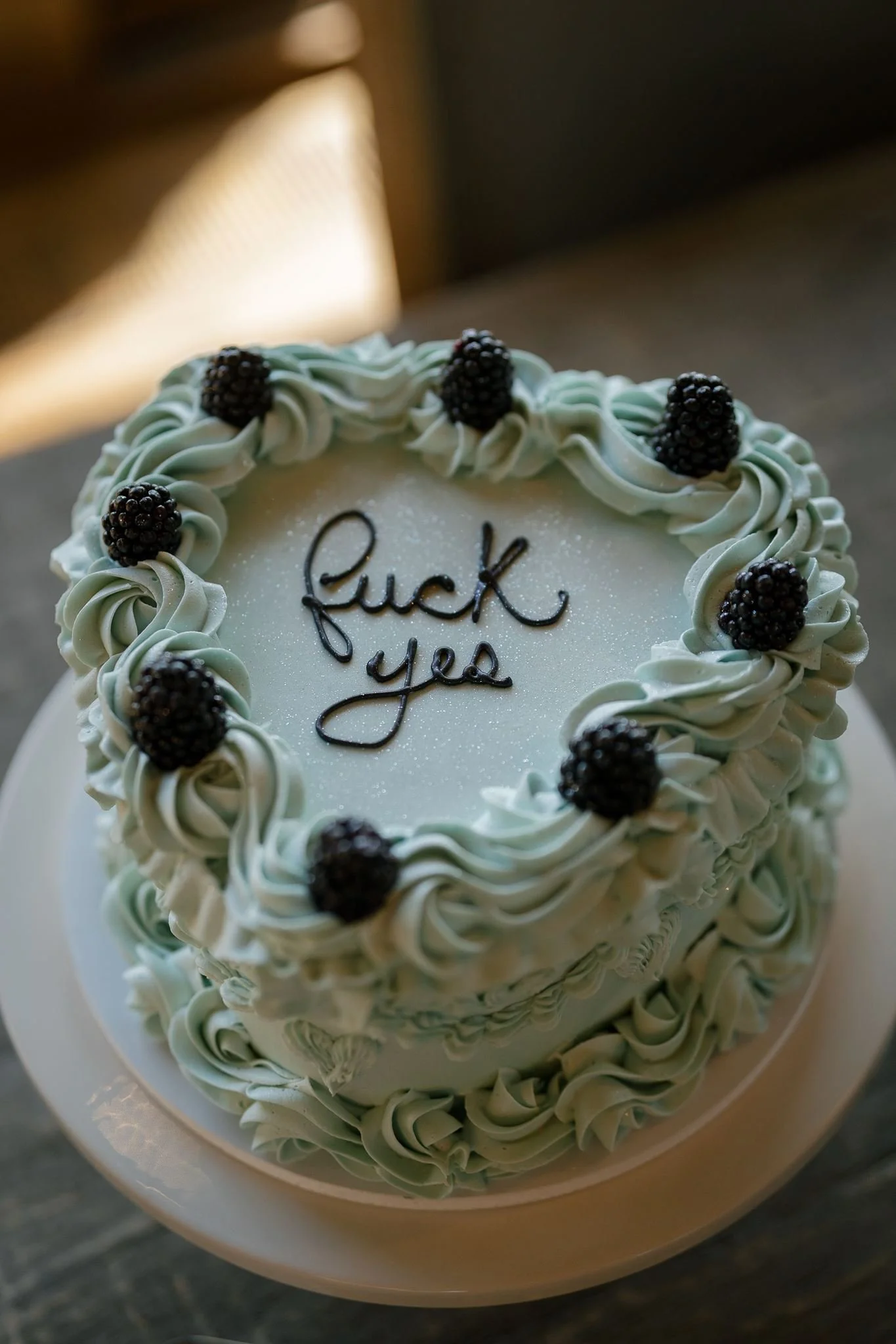 wedding cake that reads "fuck yes"