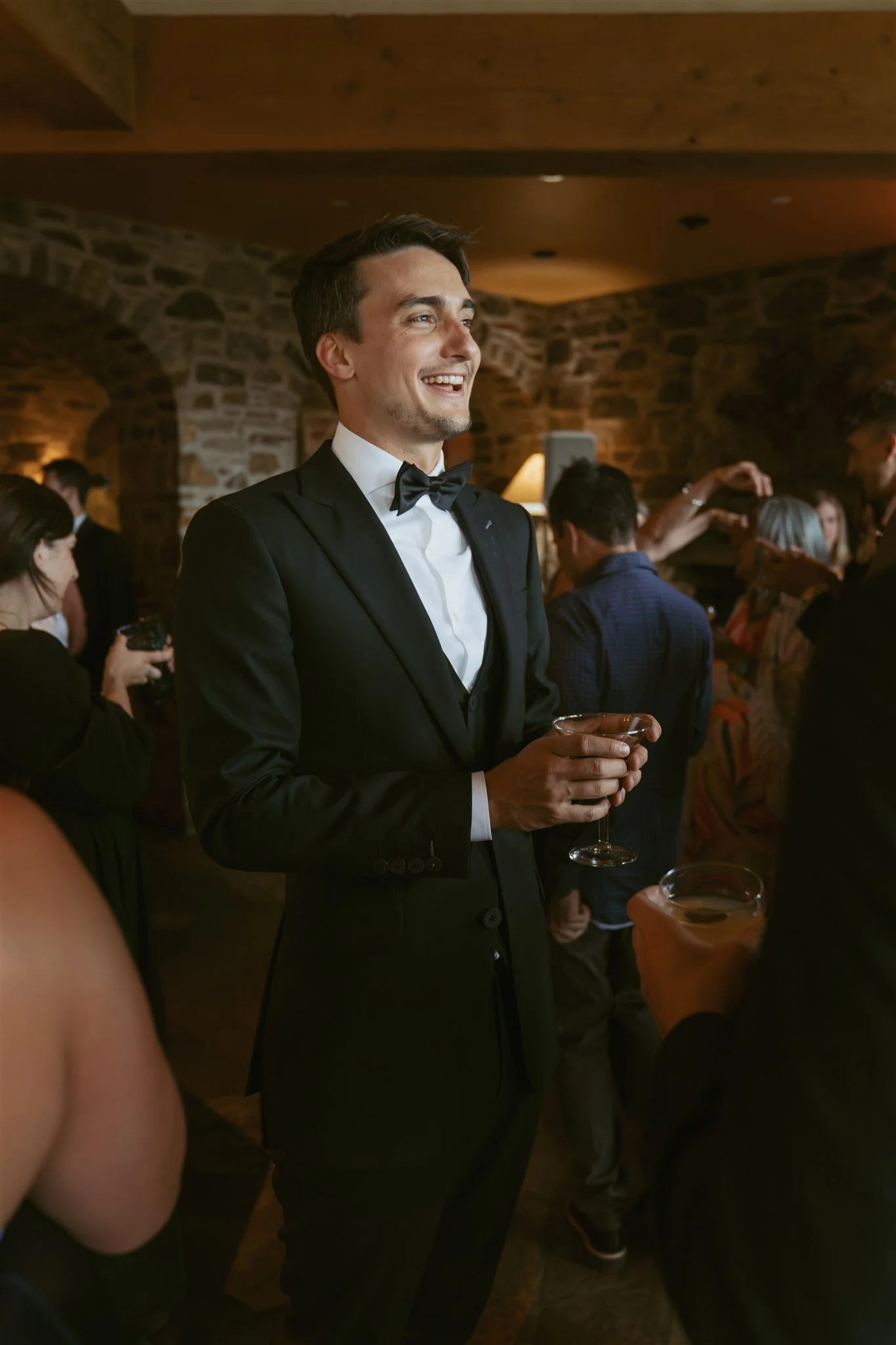 groom interacting with guests and smiling