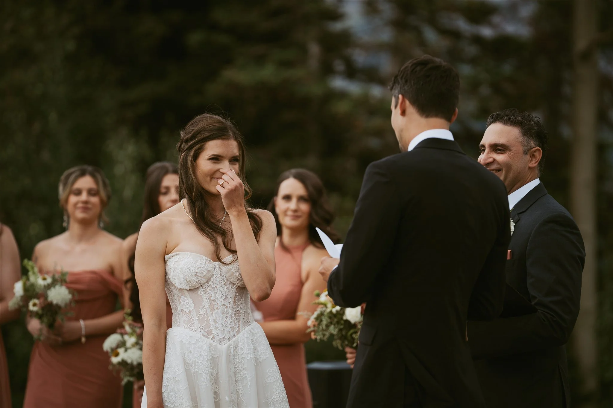 bride excitingly listening to the groom share his vows