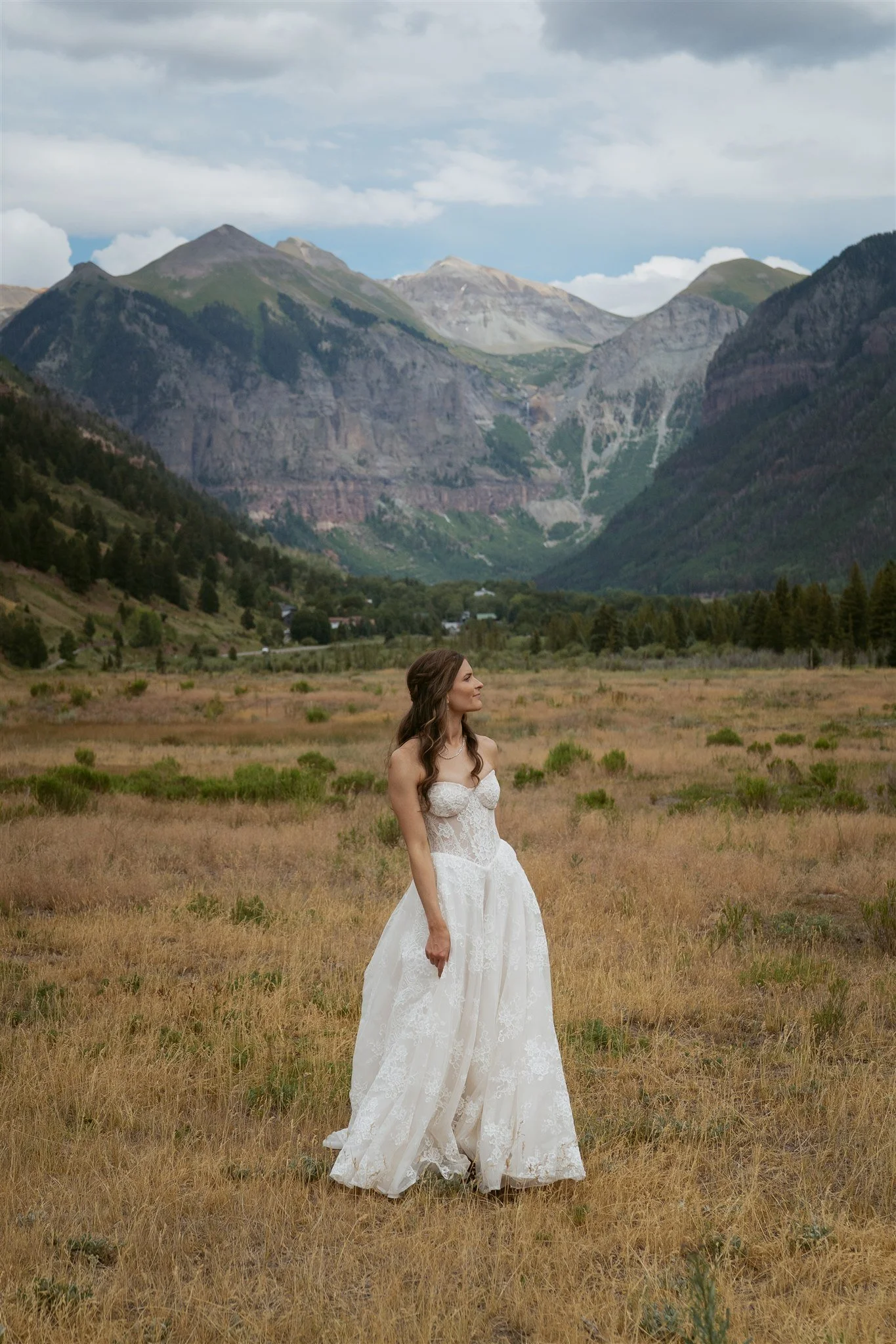bride admiring the mountain views in the Telluride valley