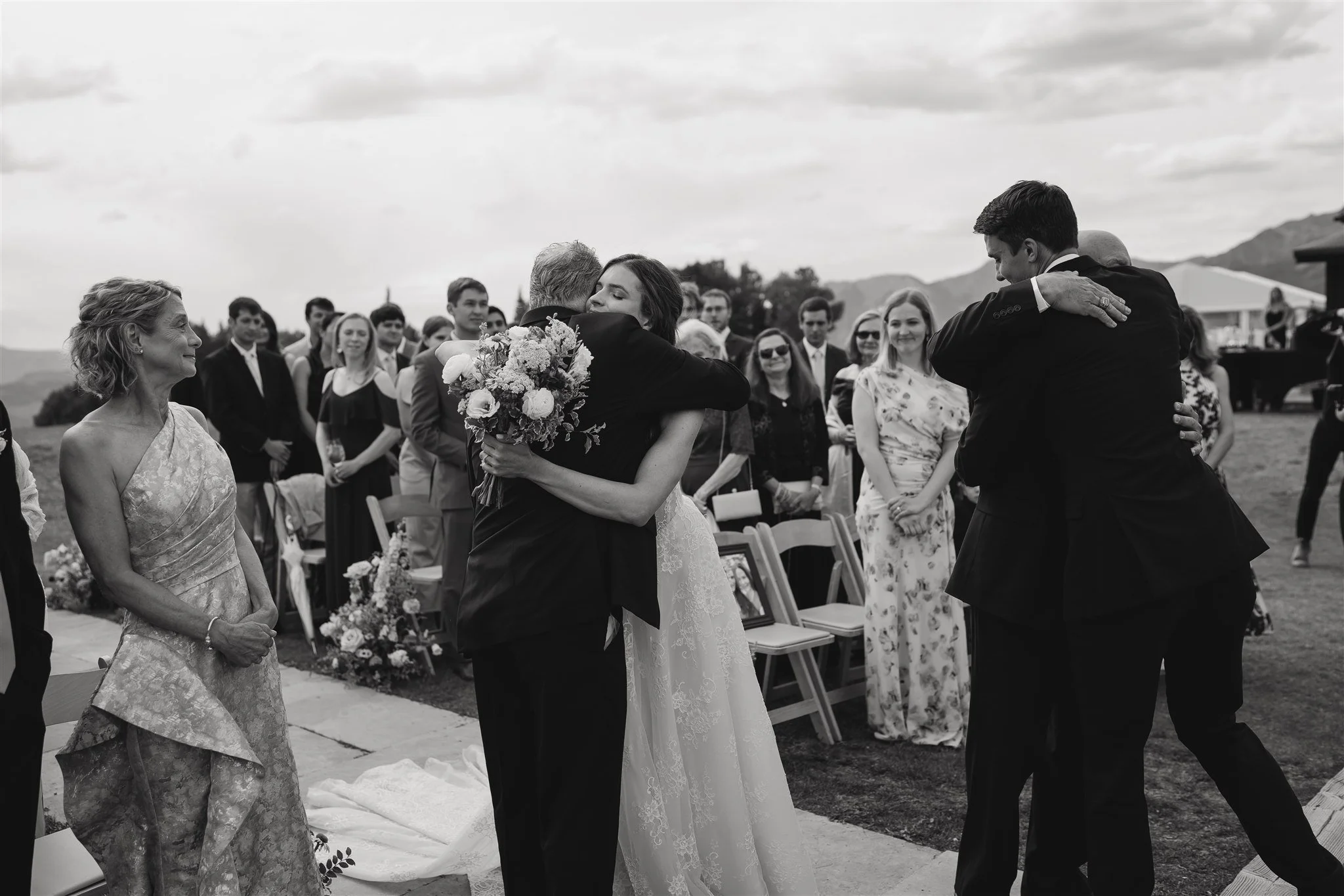 hugs after the bride is walked down the aisle