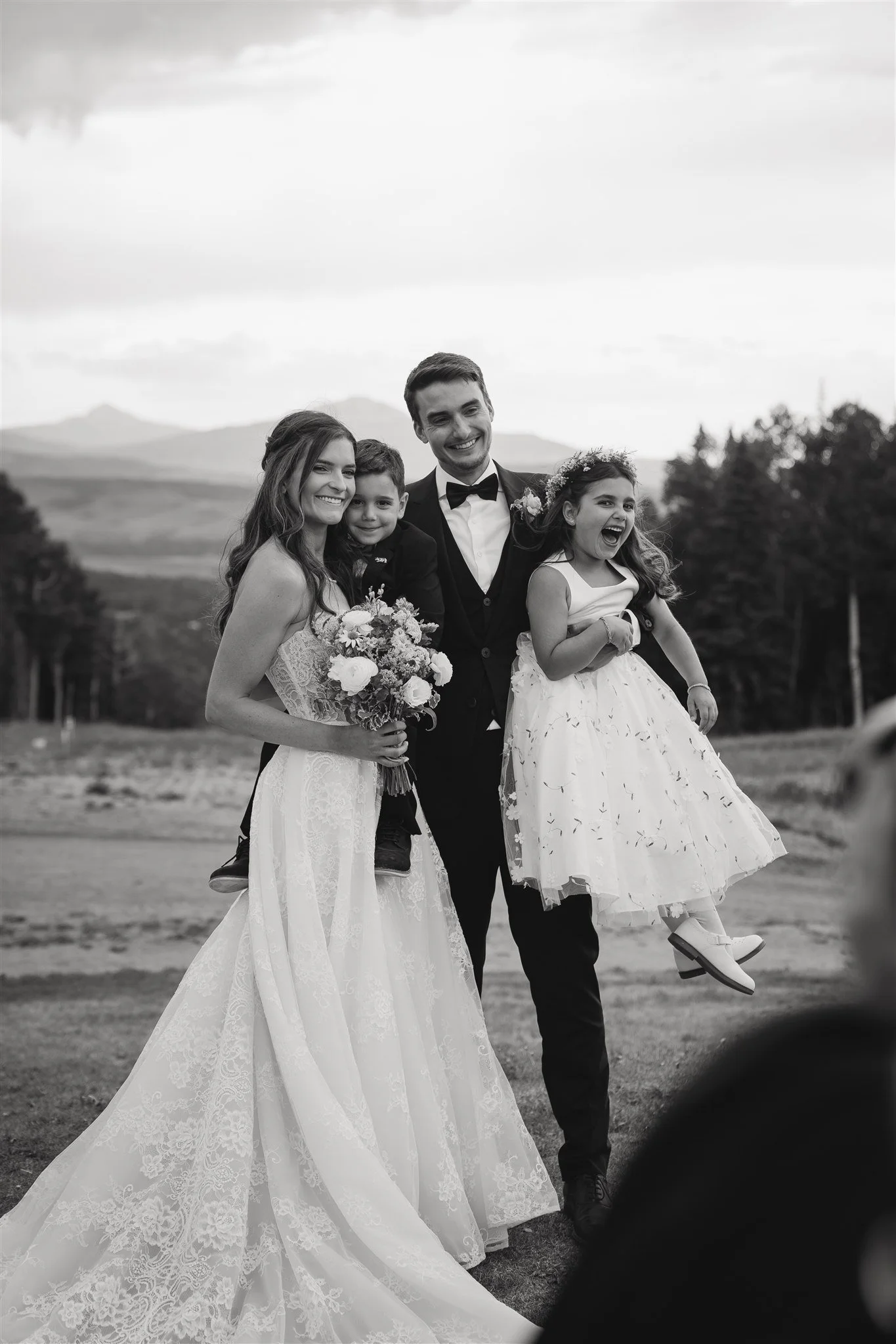 bride and groom with the officiant's children