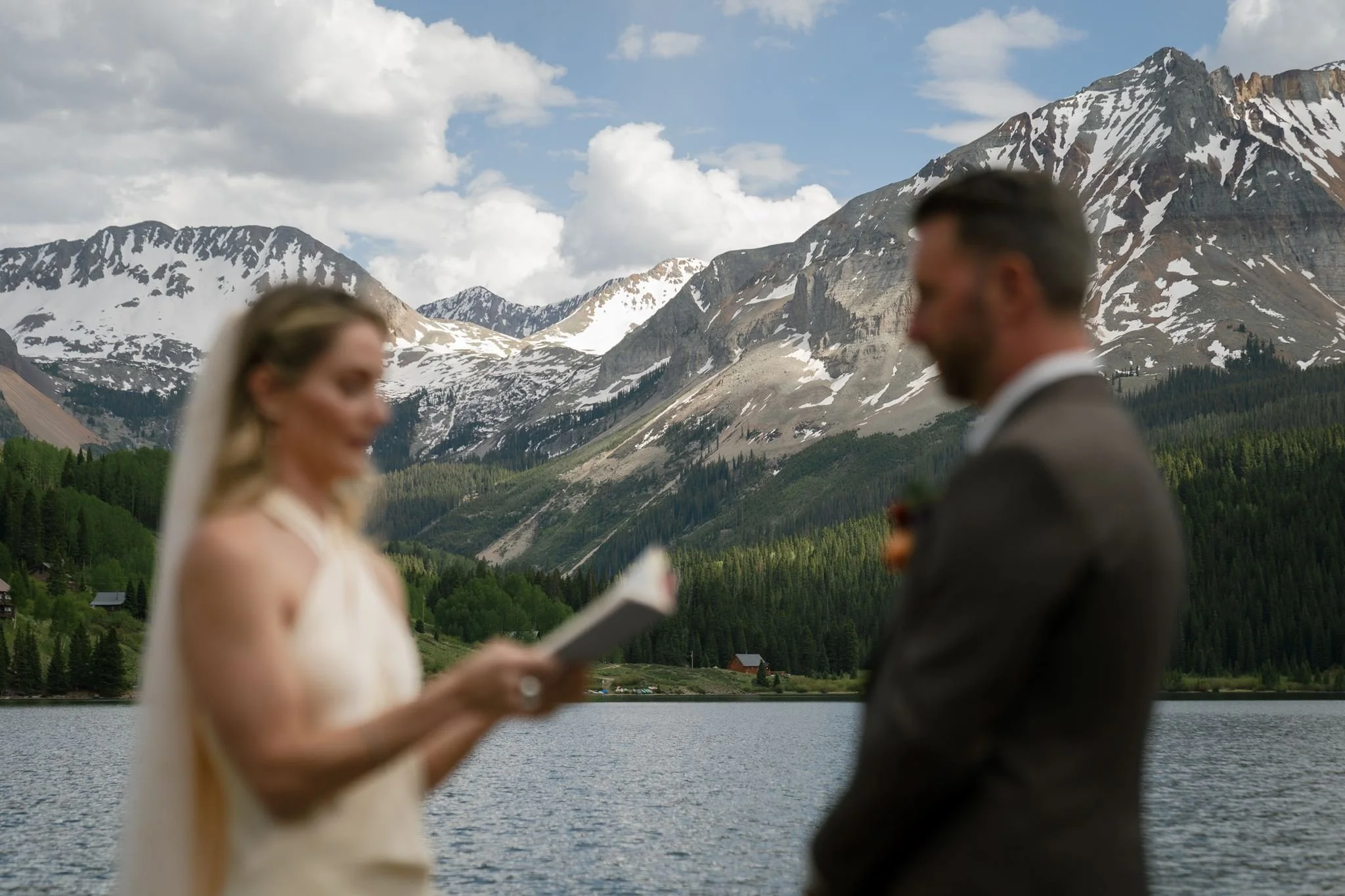 a view of the mountains through the bride and groom