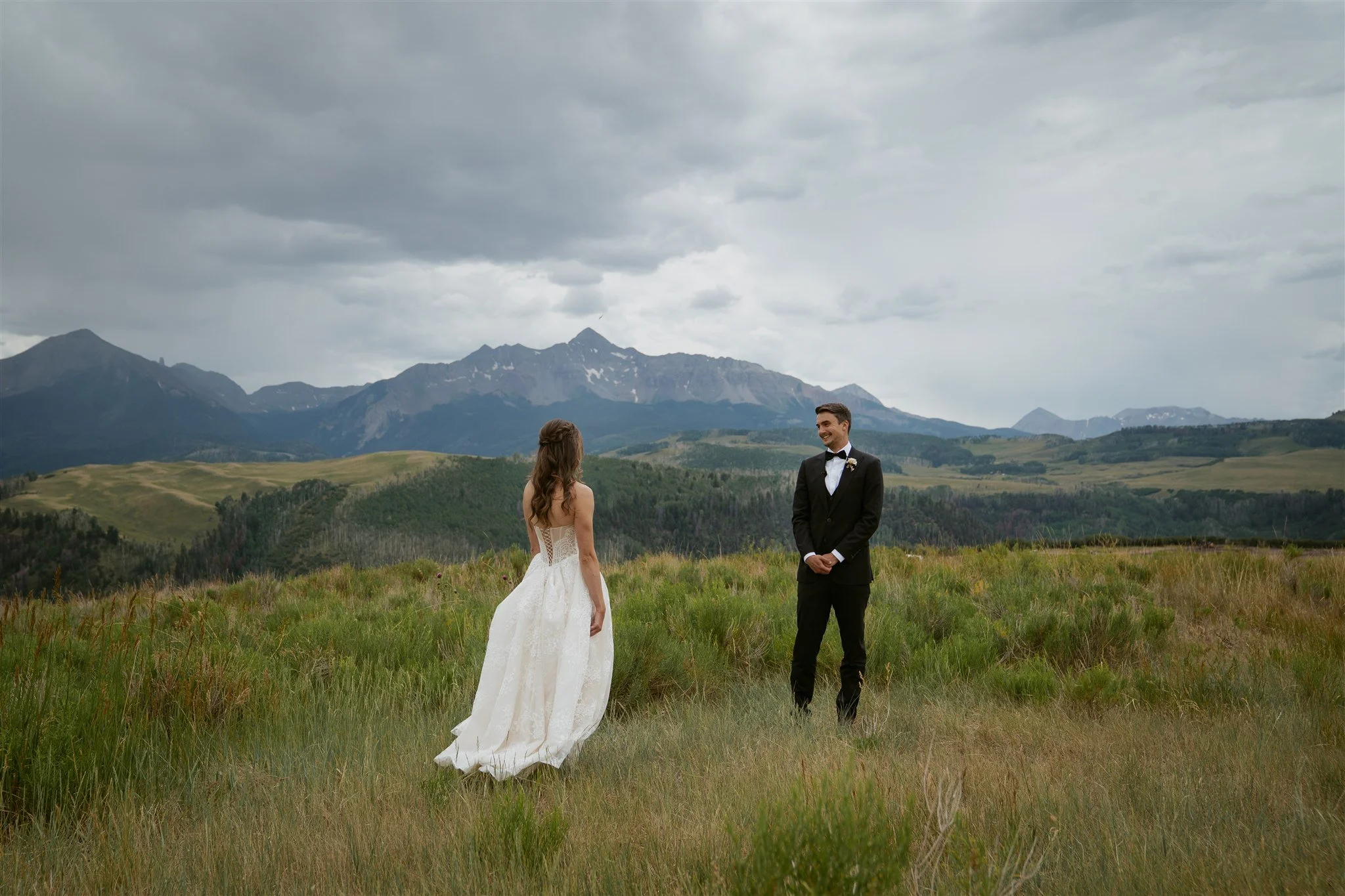Groom seeing the bride for the first time with Wilson Peak in the background