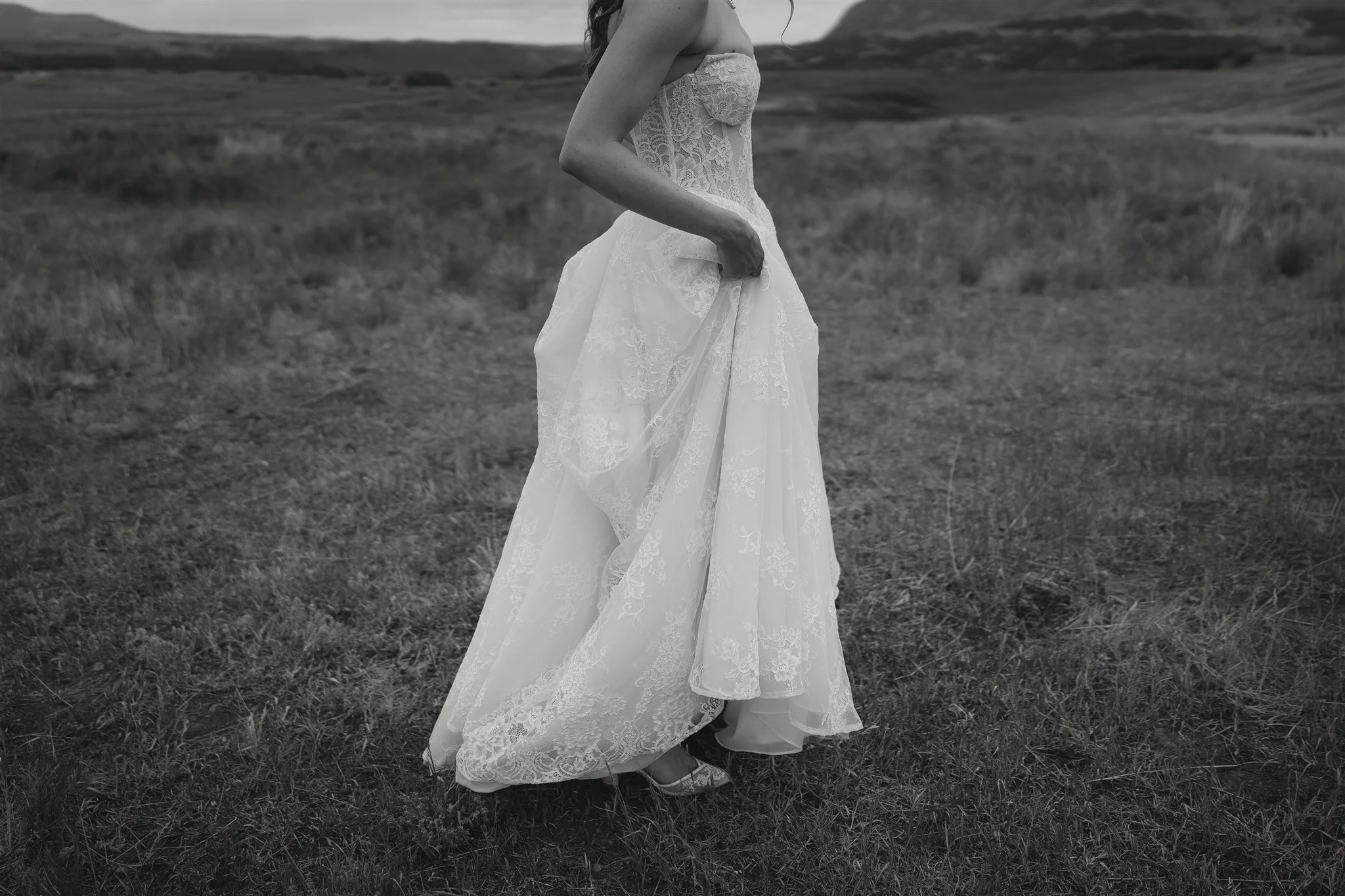detailed shot of the bride holding up her dress