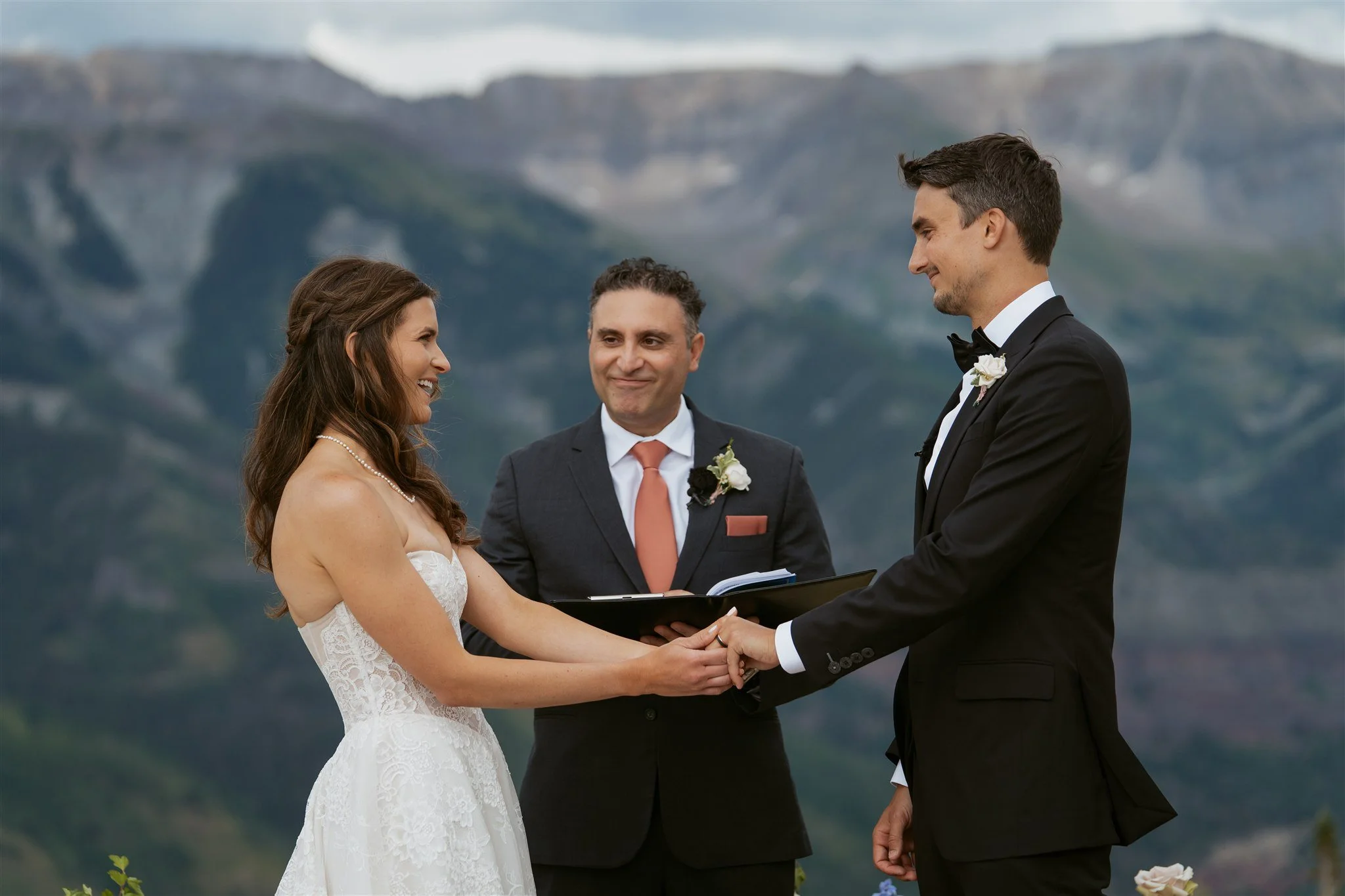 bride and groom holding hands at the altar