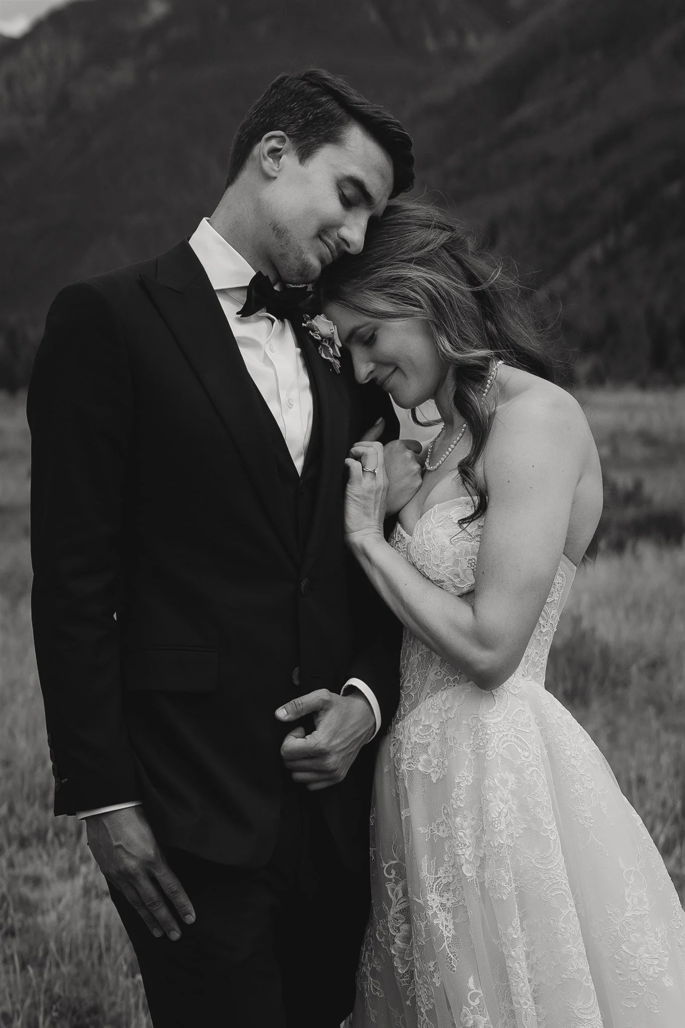 bride and groom snuggle during their portrait session