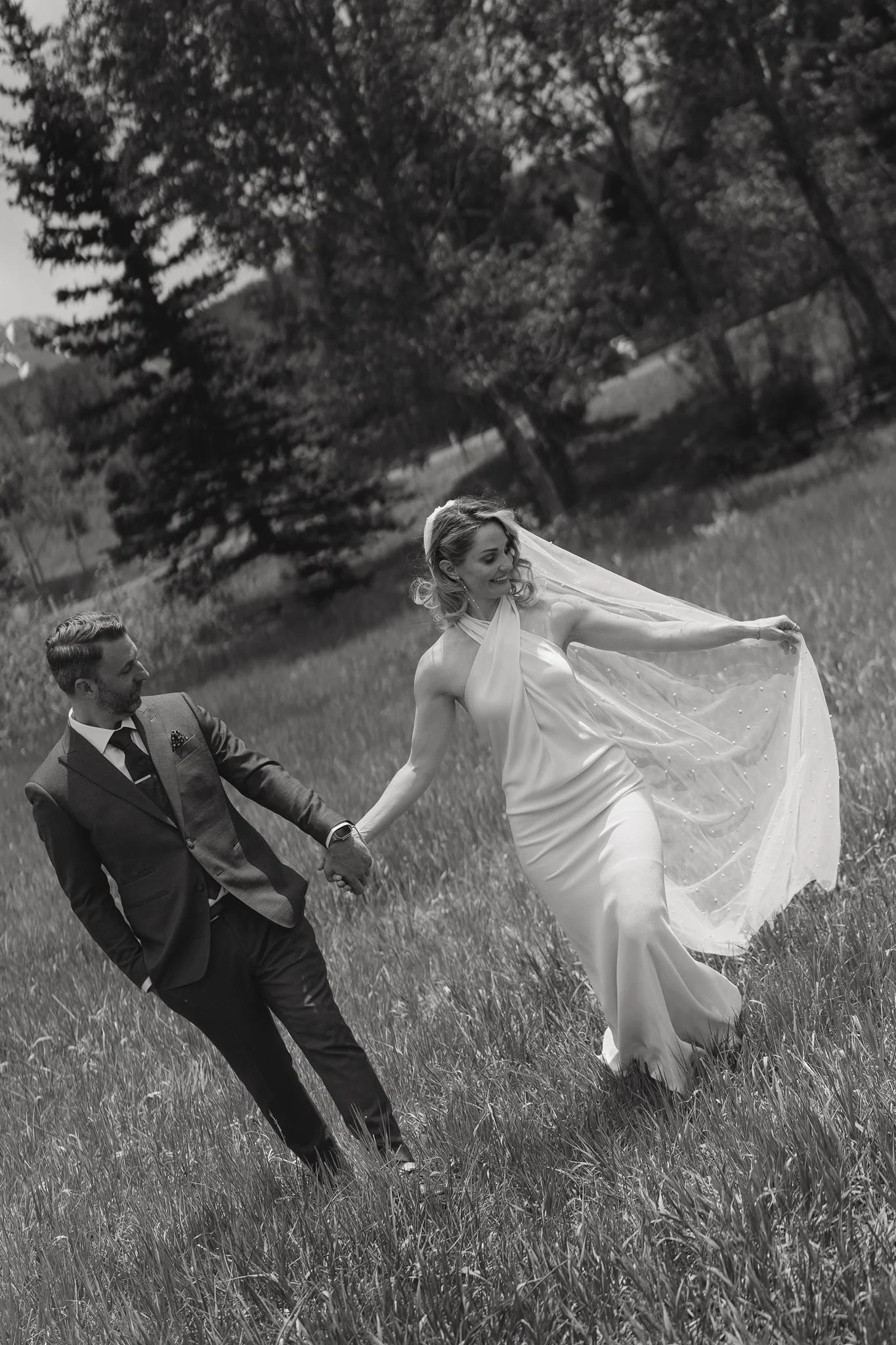 bride and groom in a grass field