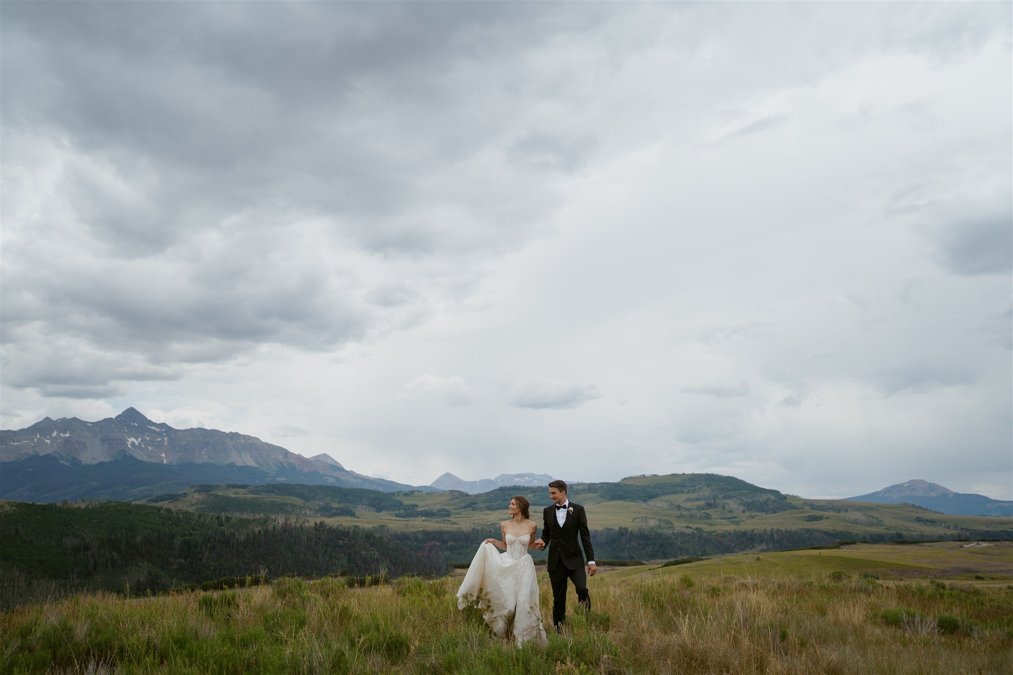 bride and groom with Wilson Peak in the background