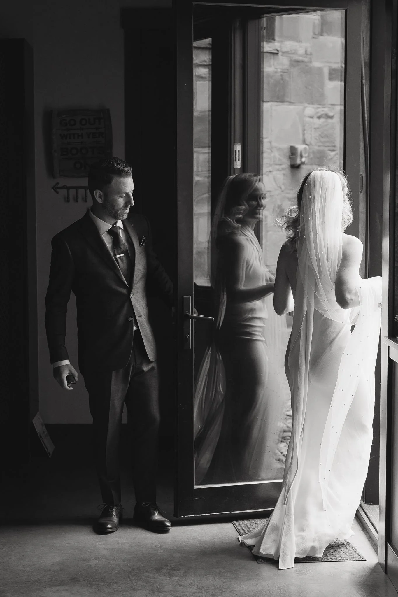 groom opens the door for his bride