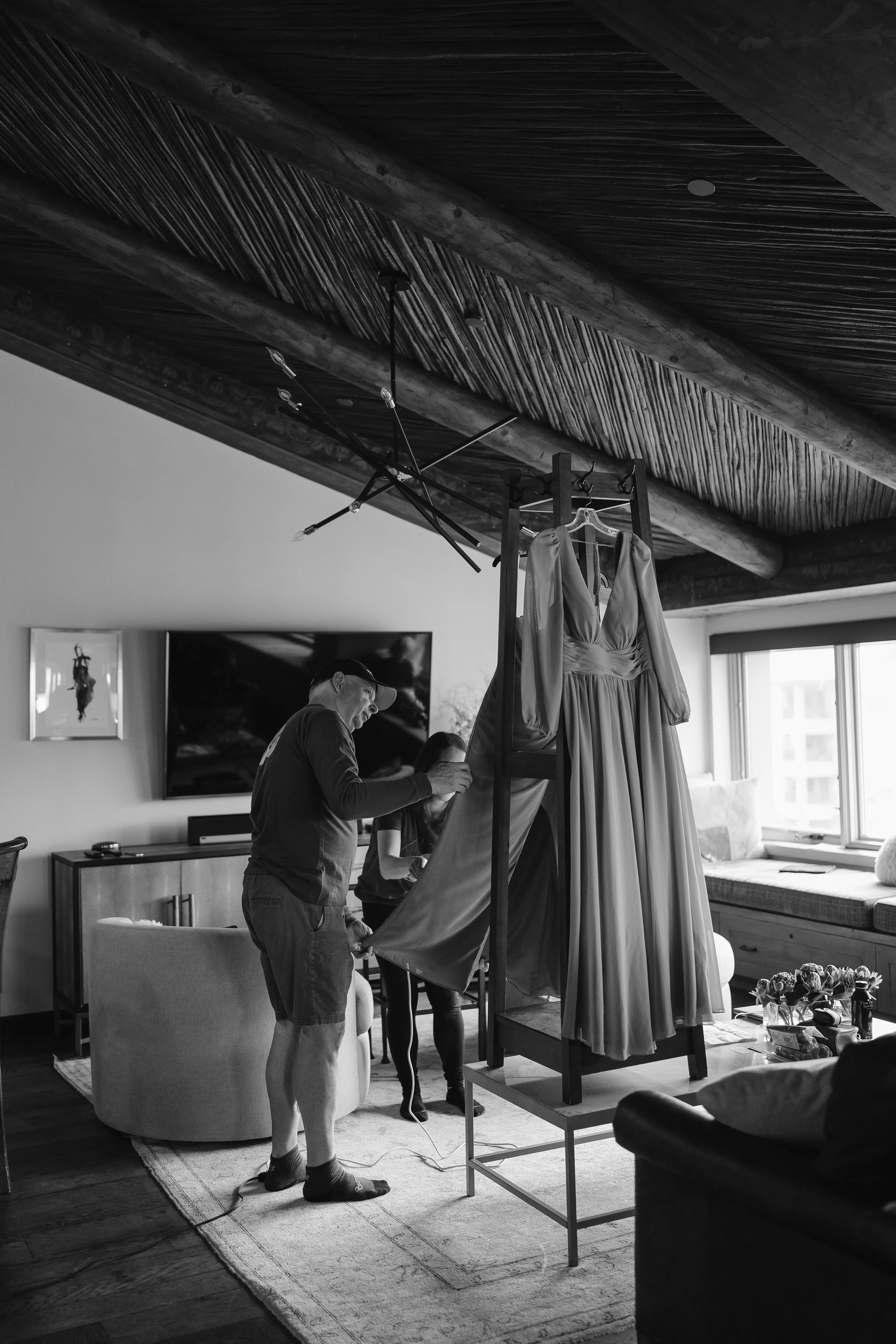 guests helping steam the bride's dress