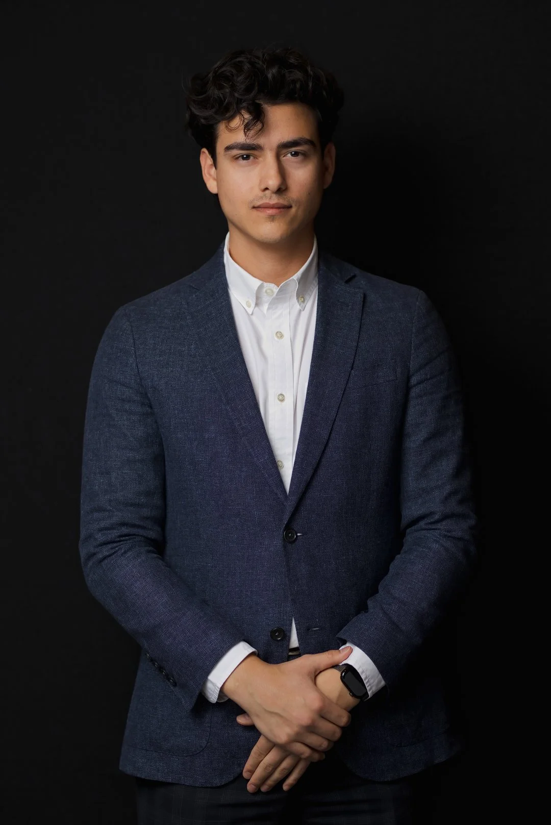 Corporate Headshot of young man wearing a blue blazer by Montreal photographer, Ella Mack