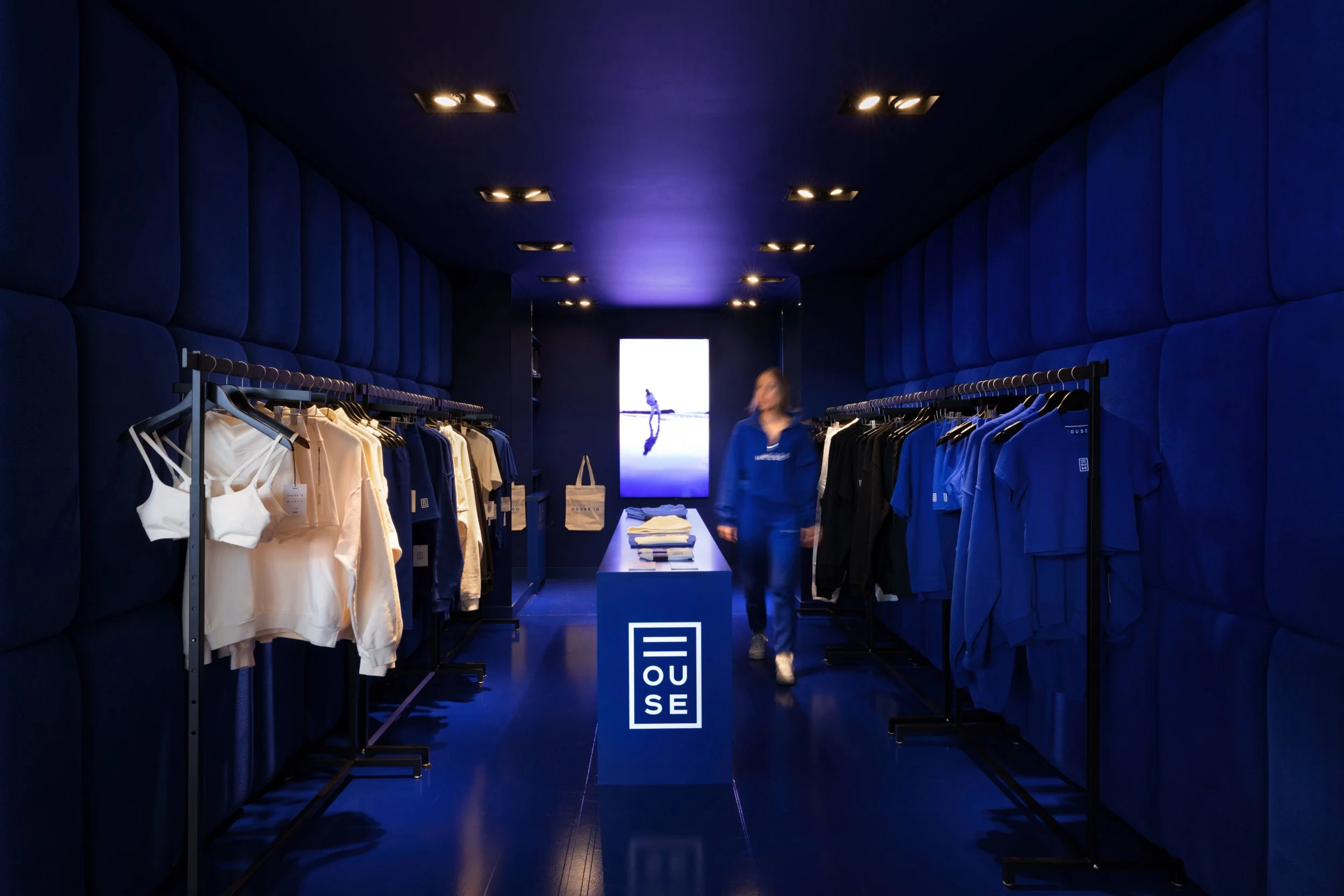 House ID in-store experience, showcasing the new retail store design. Highlights apparel displays, interactive fixtures, and the brand's overall look and feel. Demonstrates the brand's cohesive visual identity.