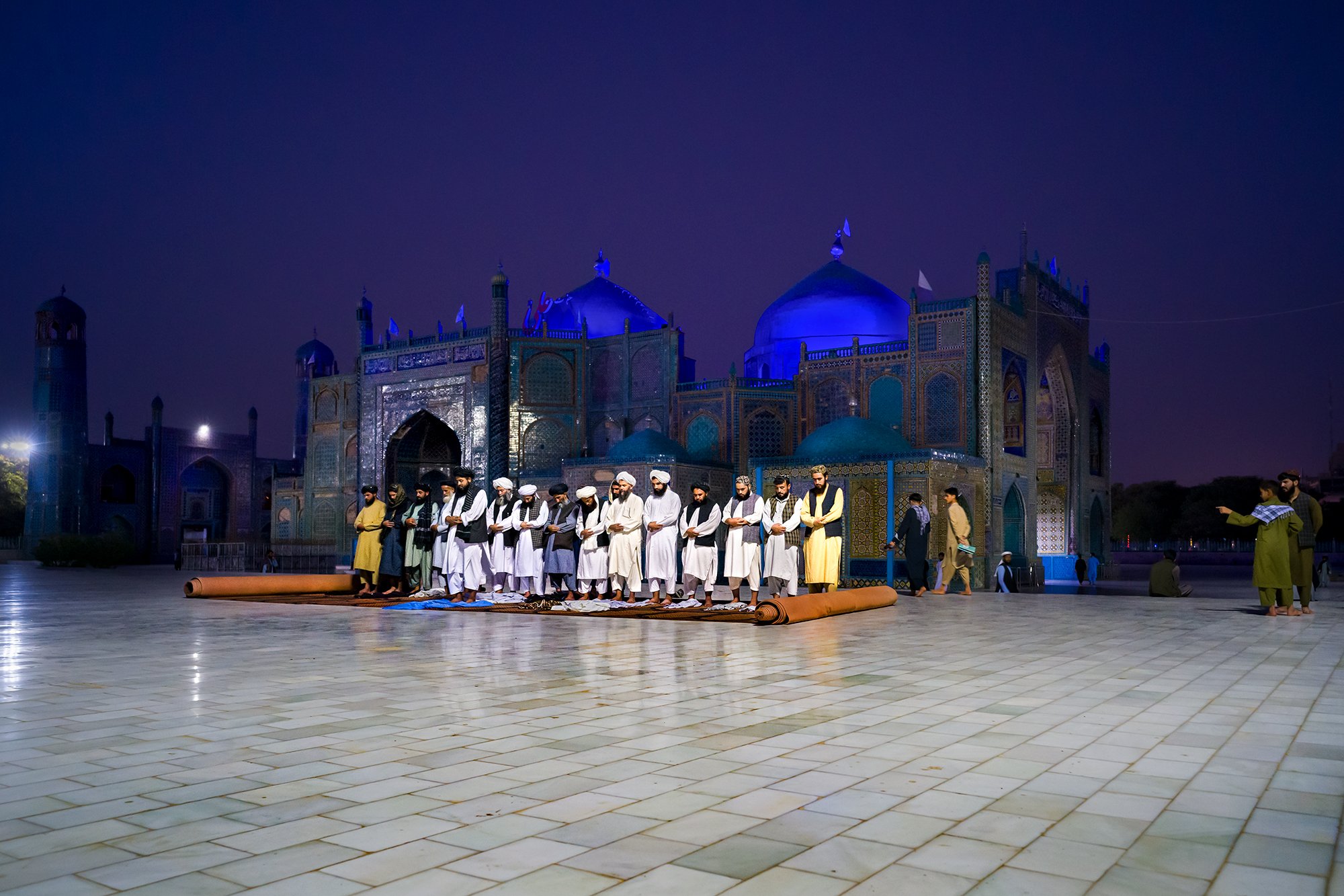 In front of the Blue Mosque in Mazar-i-Sharif, a group of Taliban gather to pray the Salat al-Maghrib, the sunset prayer. Their weapons are momentarily laid down, and the silence of faith envelops those who embody local authority, highlighting the fi