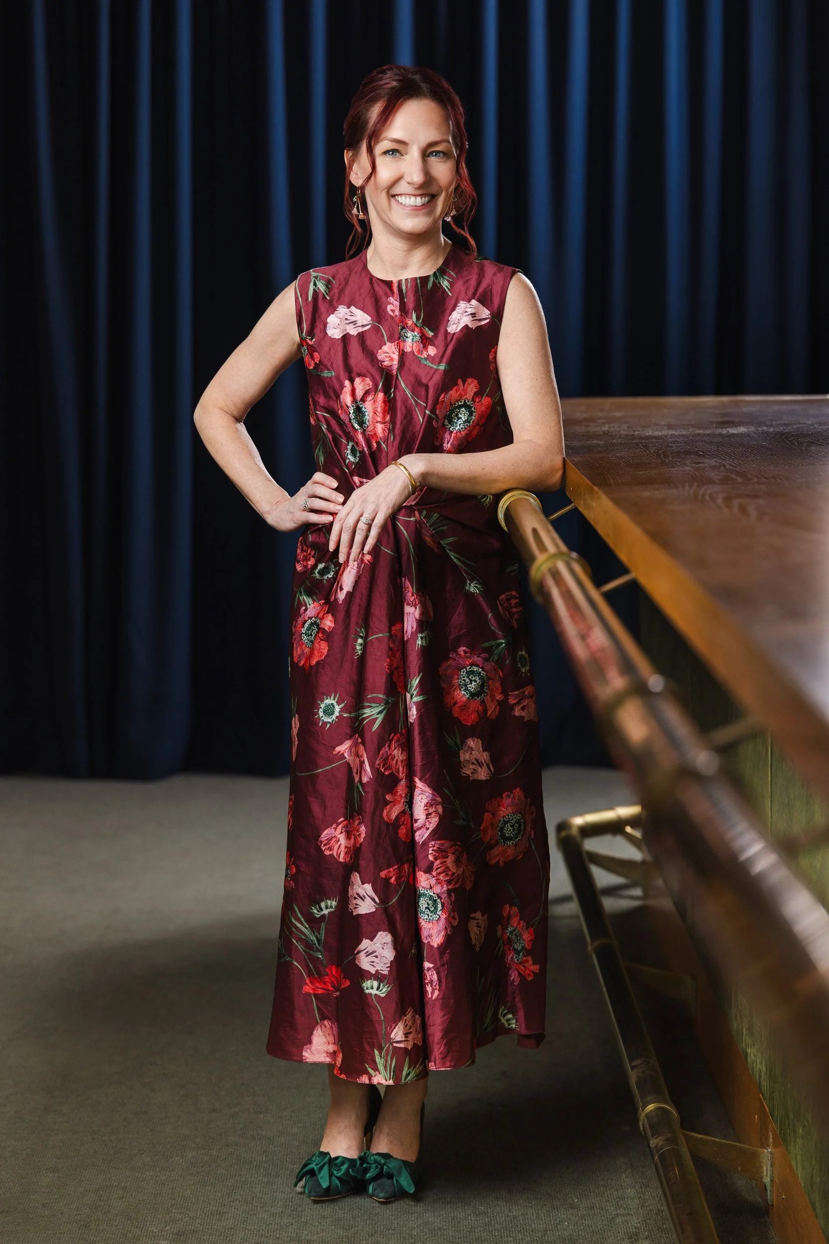 Carrie Kitko posing on the wood and brass staircase at the Fairlane Hotel, photographed by a Franklin TN editorial photographer."
