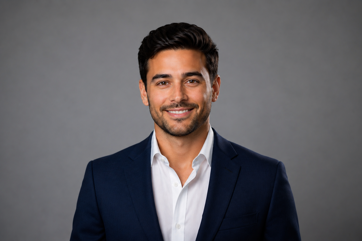 AI-generated example of a men's professional headshot showing a man in a navy suit and white shirt against a gray background, used to illustrate why AI headshots are not a substitute for a real session.