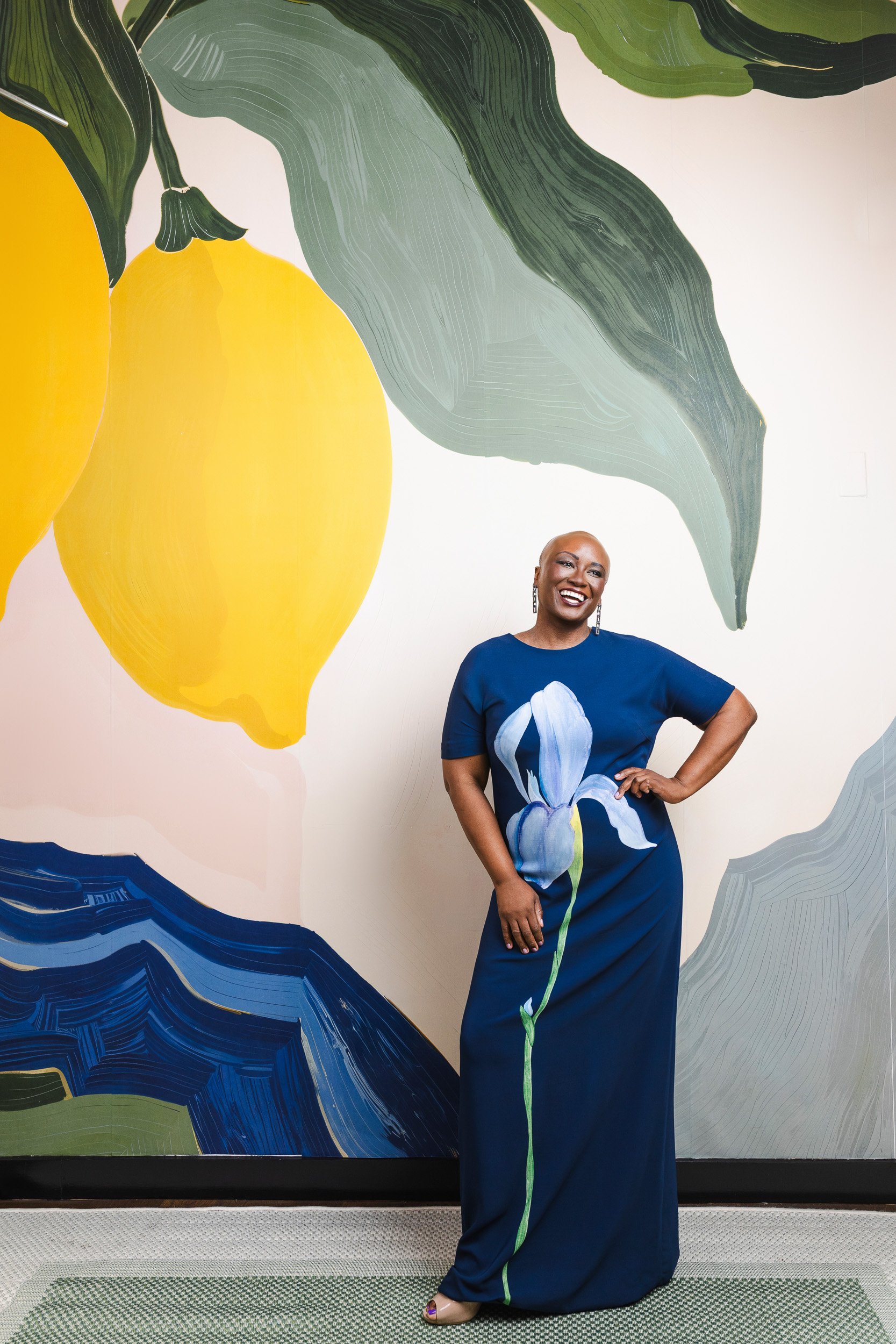 Ciona Rouse in a navy dress with a painted iris flower detail, photographed for her Nashville editorial portrait.