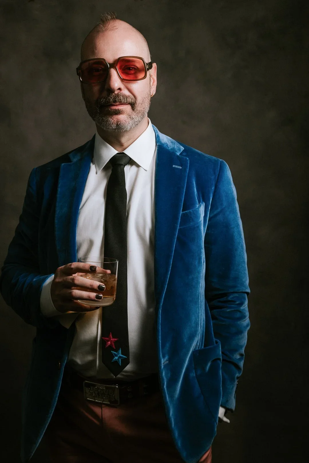 character-portrait-man-blue-velvet-sunglasses-drink.webp