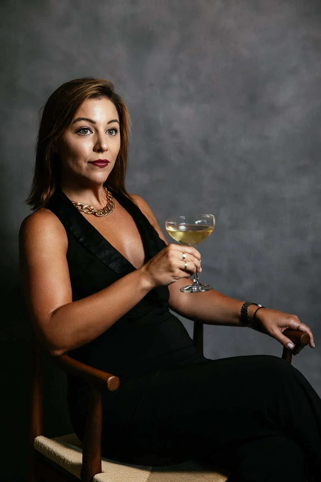 event-portrait-woman-wine-glass-black-dress.webp