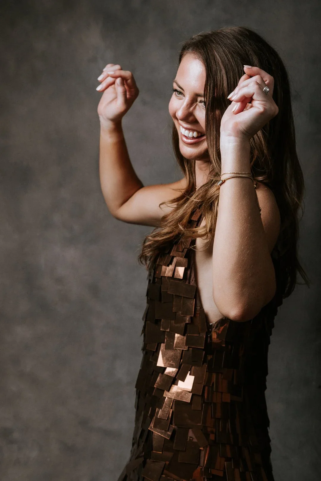 energetic-portrait-woman-brown-sequin-smile.webp