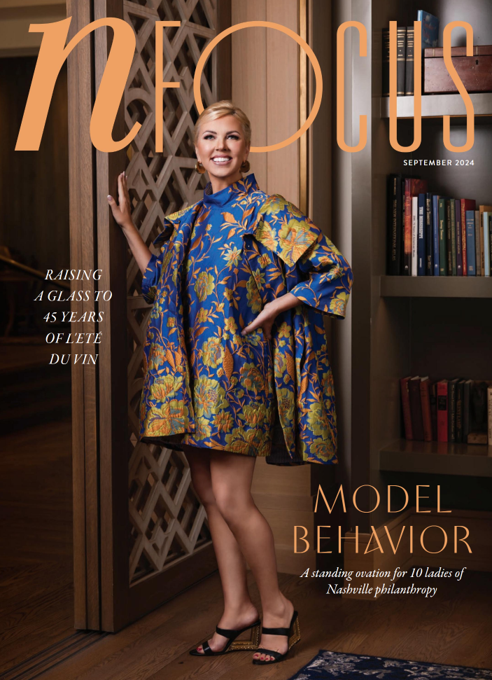A powerful portrait set against a rich wood background, showcasing elegant attire and poised confidence. Nashville Headshot Photographer delivering portraits that exude professionalism and personality.