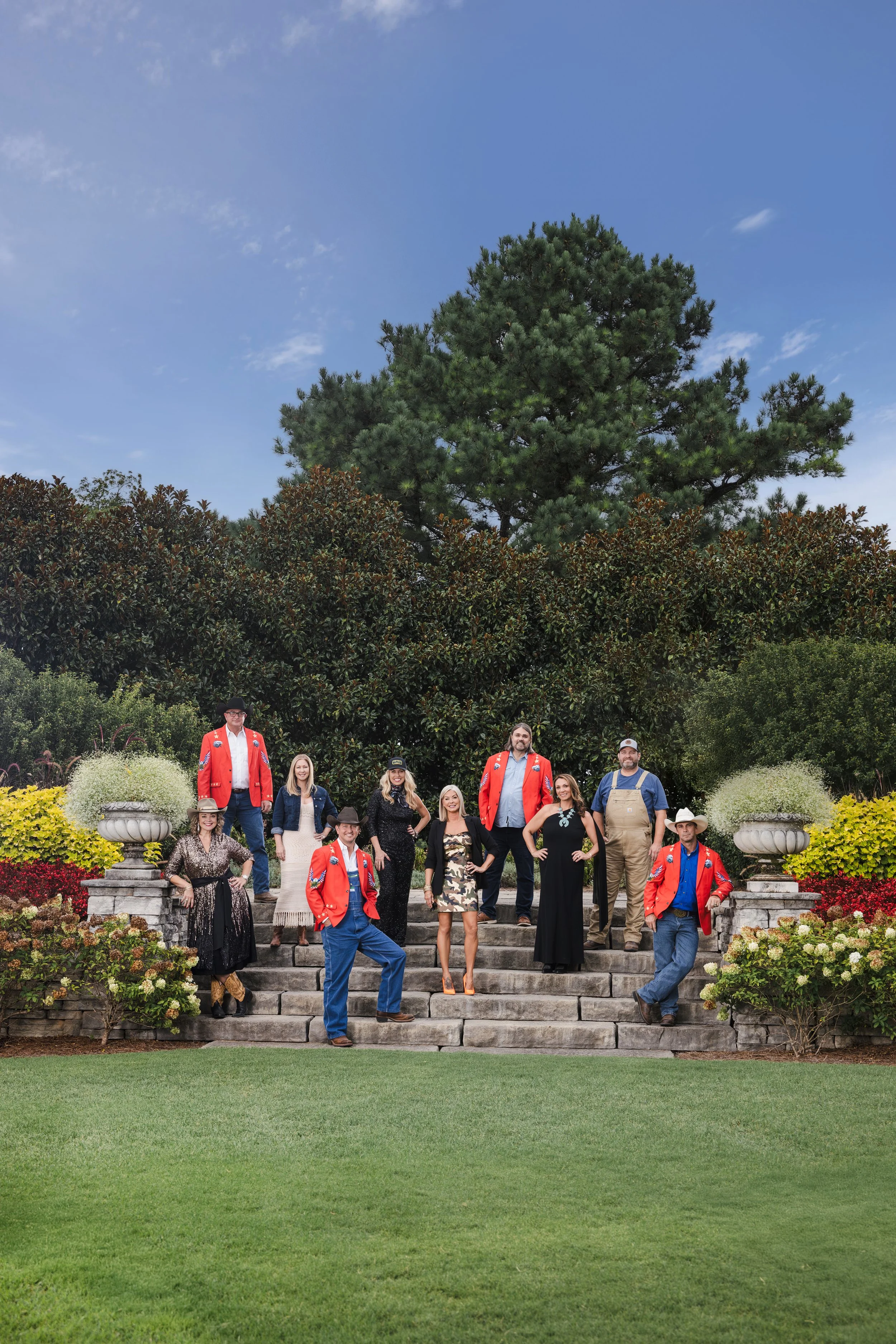Colorful outdoor group photo on the garden steps of Eastern Flank Battlefield Park, featuring the 2025 Hog Ball committee. Captured by Franklin event photographer Tausha Dickinson for a Southern lifestyle magazine cover feature.