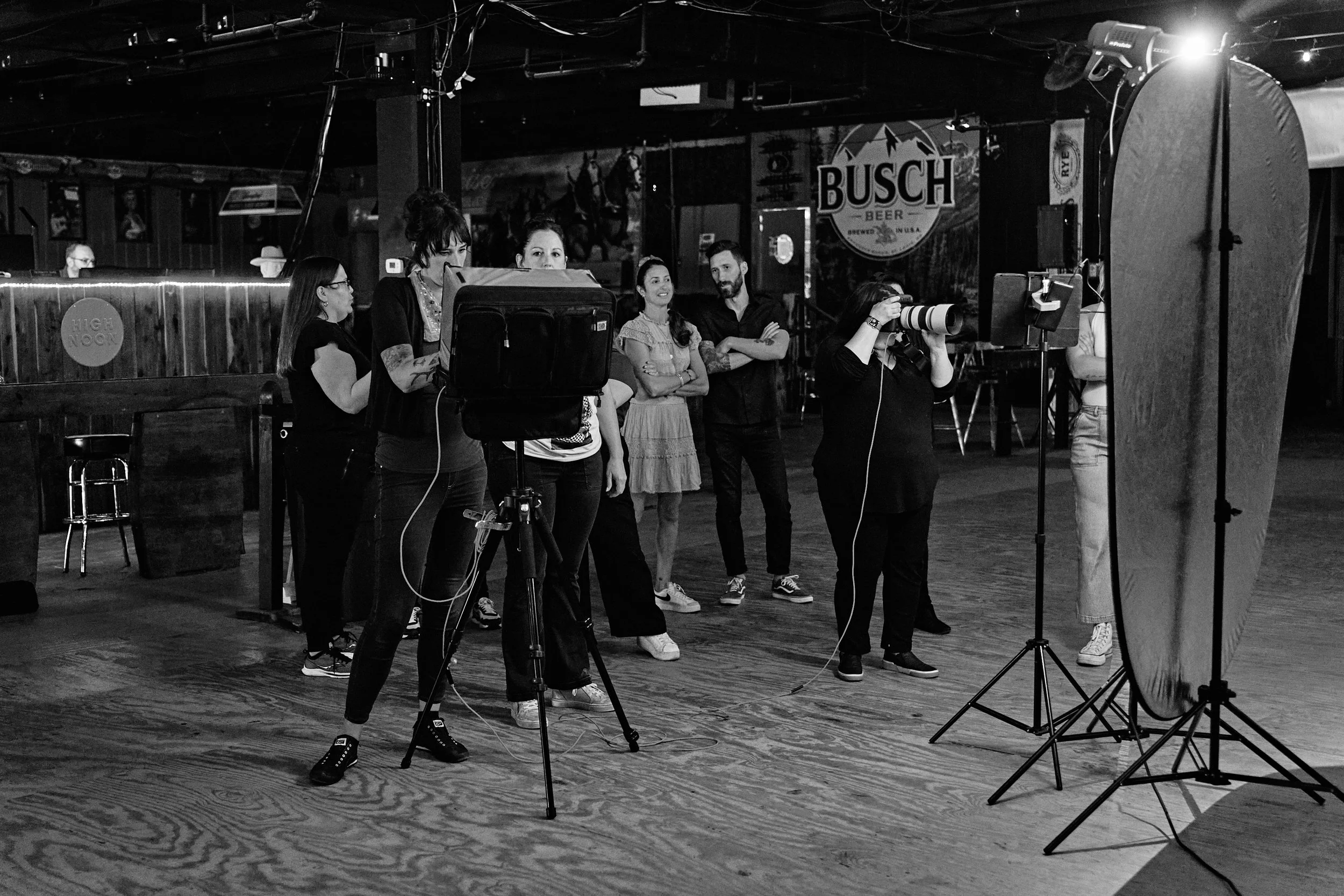 Black and white behind the scenes image of a large photography workshop group shooting on location in Nashville