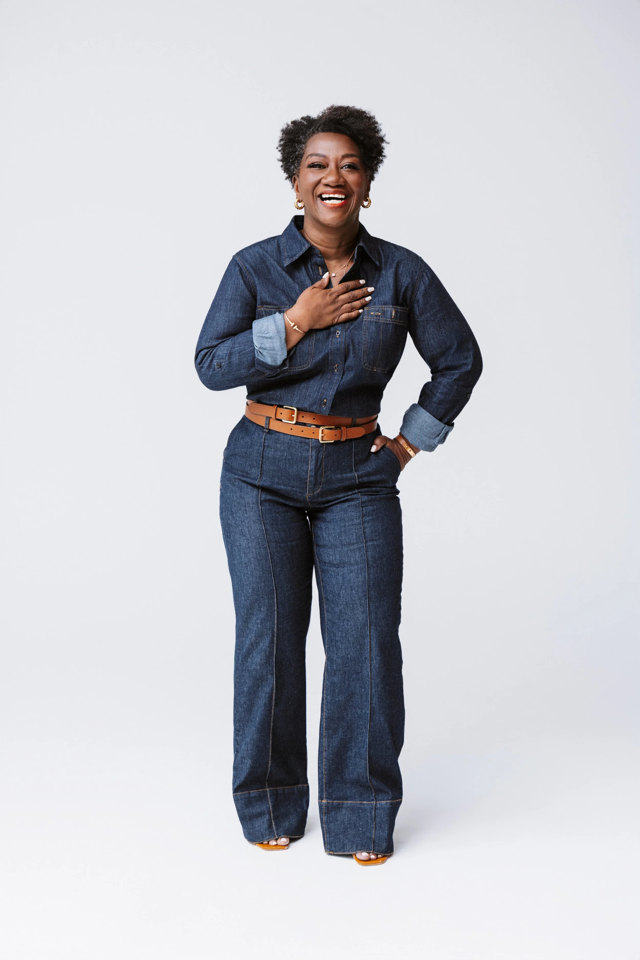A branding photo full of life, energy, and confidence. Tressie’s mid-motion stance in a red suit brings personality to the forefront—captured by a Nashville Photographer skilled in modern, movement-forward portraits.