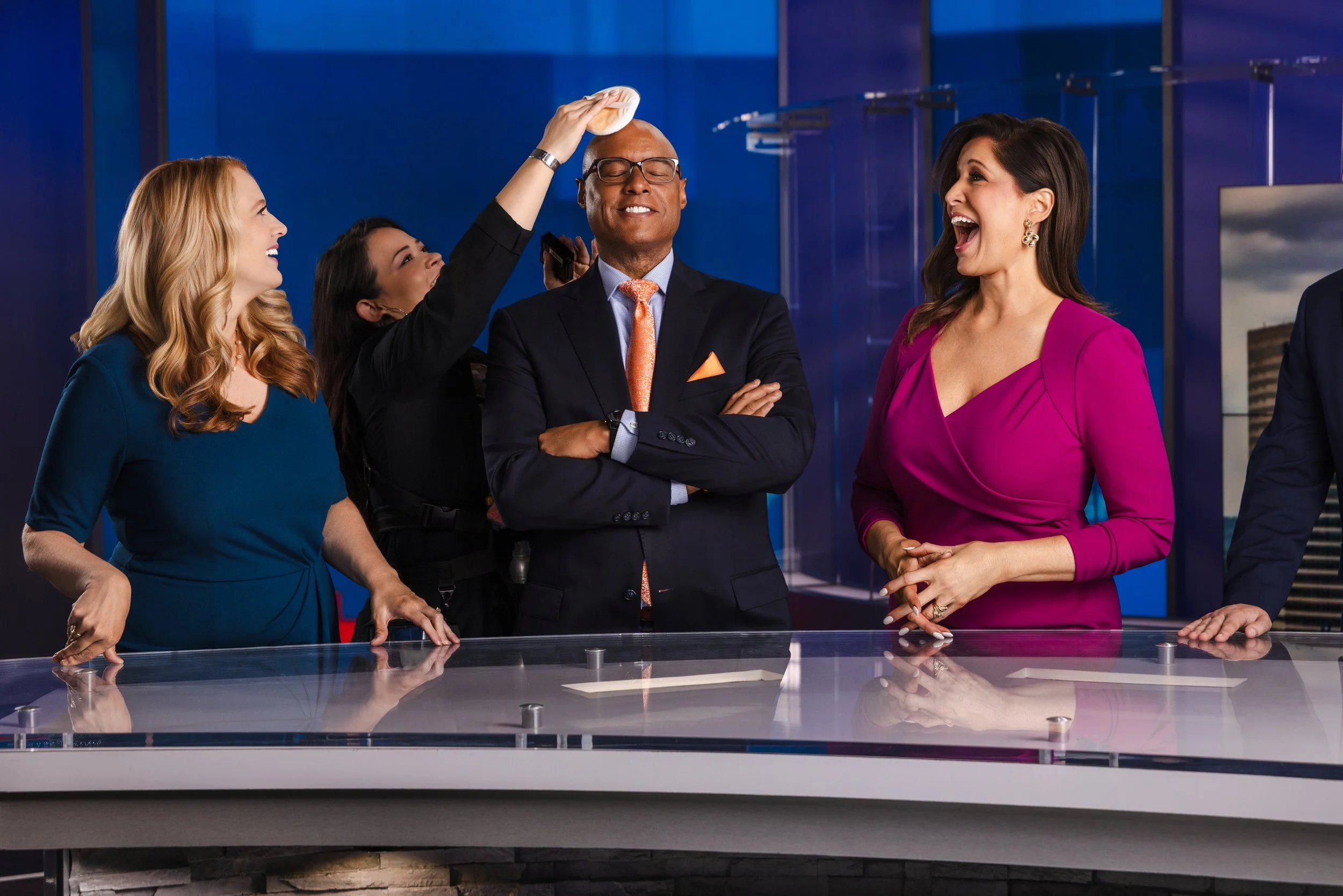Behind-the-scenes moment of WSMV news anchors laughing during a studio shoot in Nashville, photographed by Tausha Dickinson.