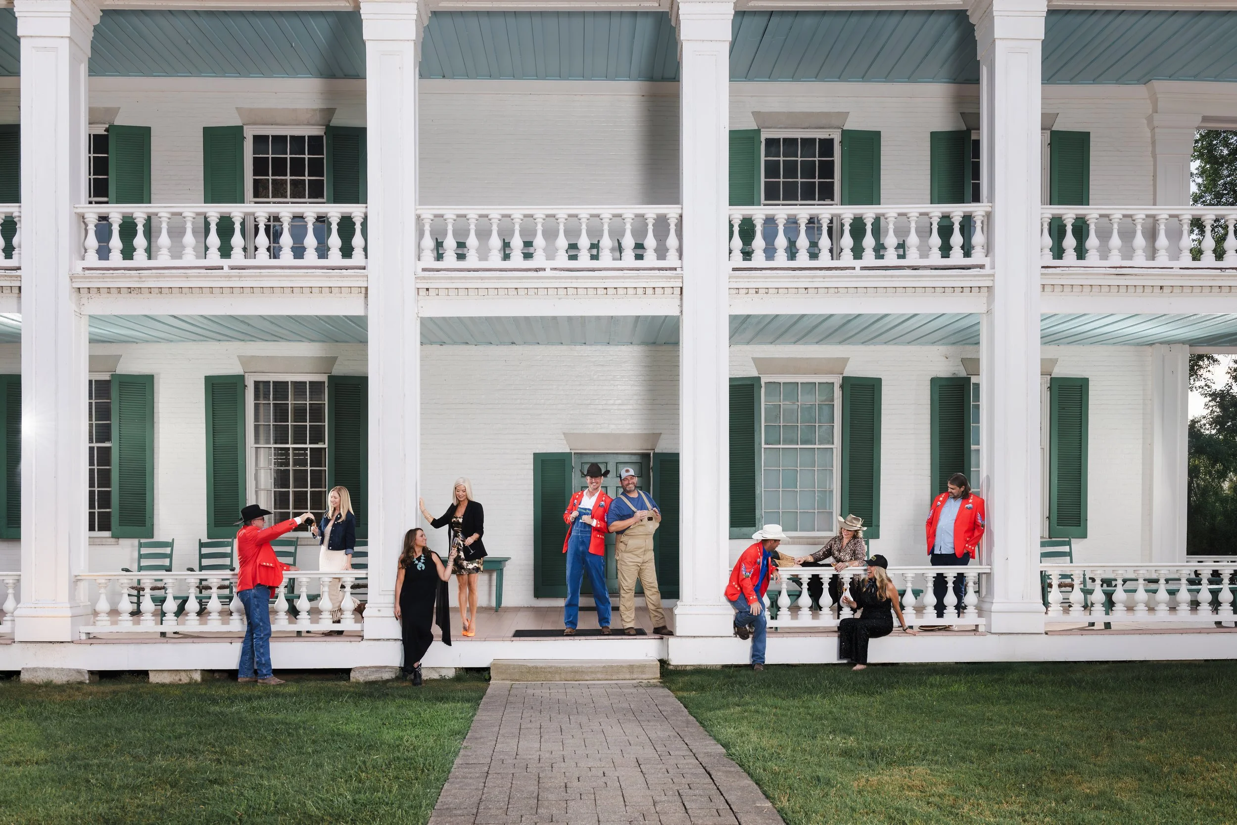 Group photo of the Hog Ball committee on the porch of Eastern Flank Battlefield Park in Franklin, Tennessee. Captured by Nashville commercial photographer Tausha Dickinson for the September 2025 cover of YOUR WILLIAMSON magazine.