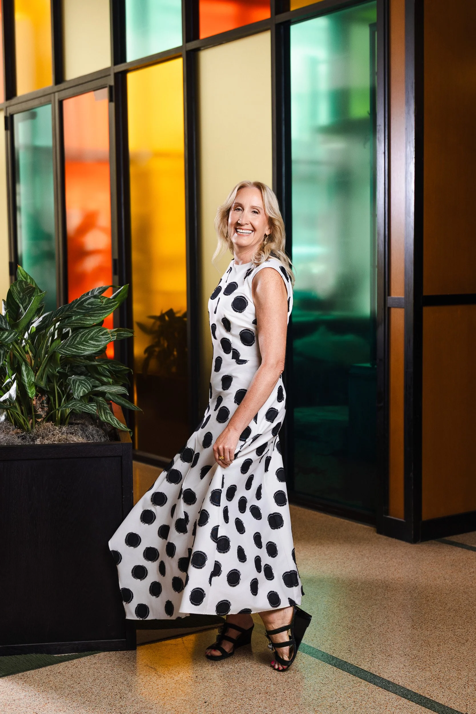 Jennifer Biefel's polka dot dress caught mid-motion against the stained glass wall during her Nashville editorial photography session.