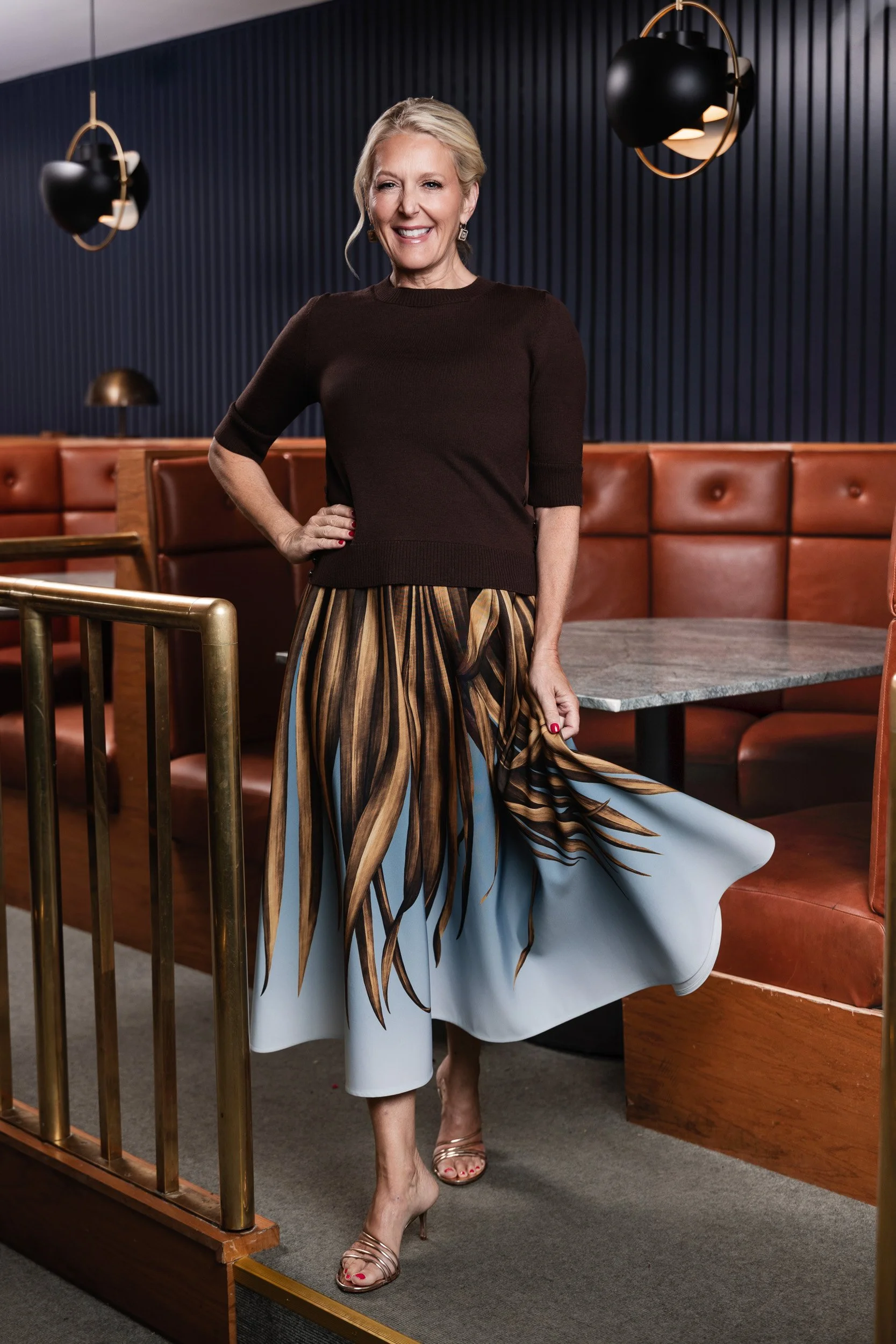 Caroline Cook's palm print skirt caught in motion at the Fairlane Hotel bar, photographed during her Nashville editorial portrait session."