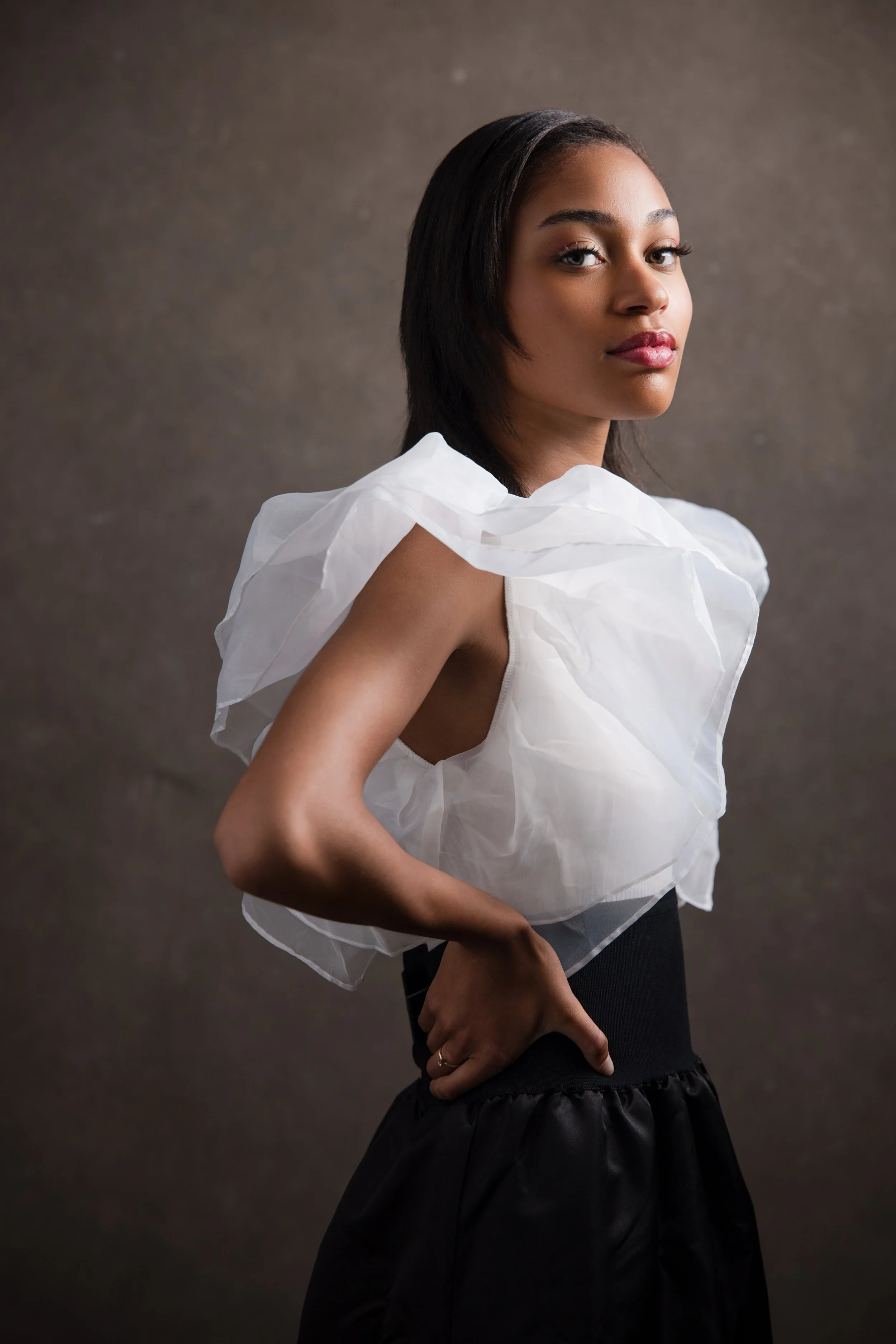 Studio portrait with umbrella diffusion modifier creating soft, flattering light