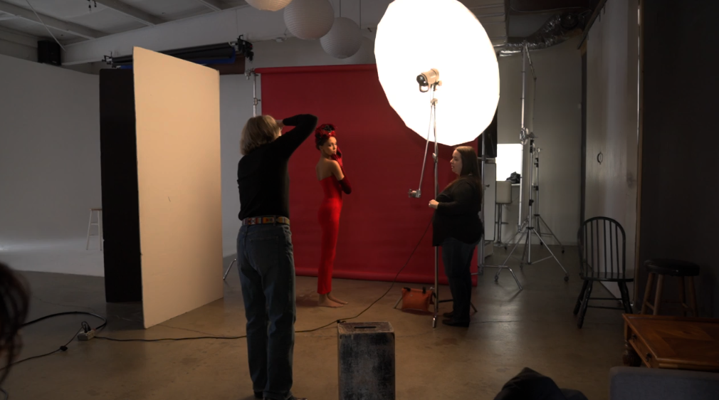 Behind the scenes of a studio portrait session using a large octobox and red backdrop, from a hands-on Nashville photography workshop