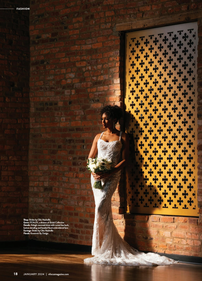 A stunning bridal portrait captured with dramatic lighting and architectural textures. This photo showcases a bride in a lace gown, bathed in golden light against a textured brick wall—perfect for modern yet timeless wedding photography. Nashville Fa