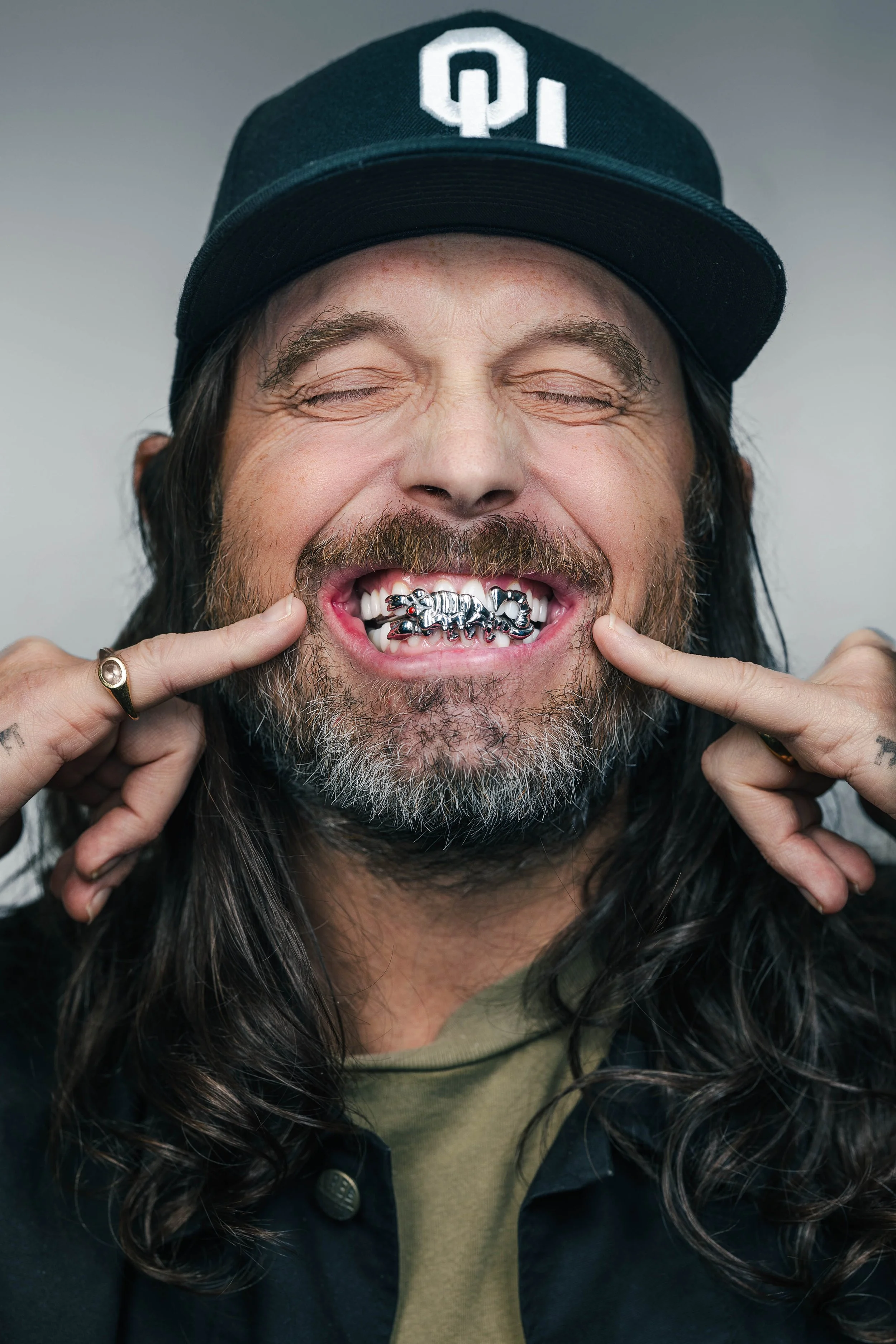 Nathan Followill of Kings of Leon showing his custom scorpion grill by Style Dentlab, commissioned by Dr. Daniel Weese of Nashville Aesthetic Dentistry
