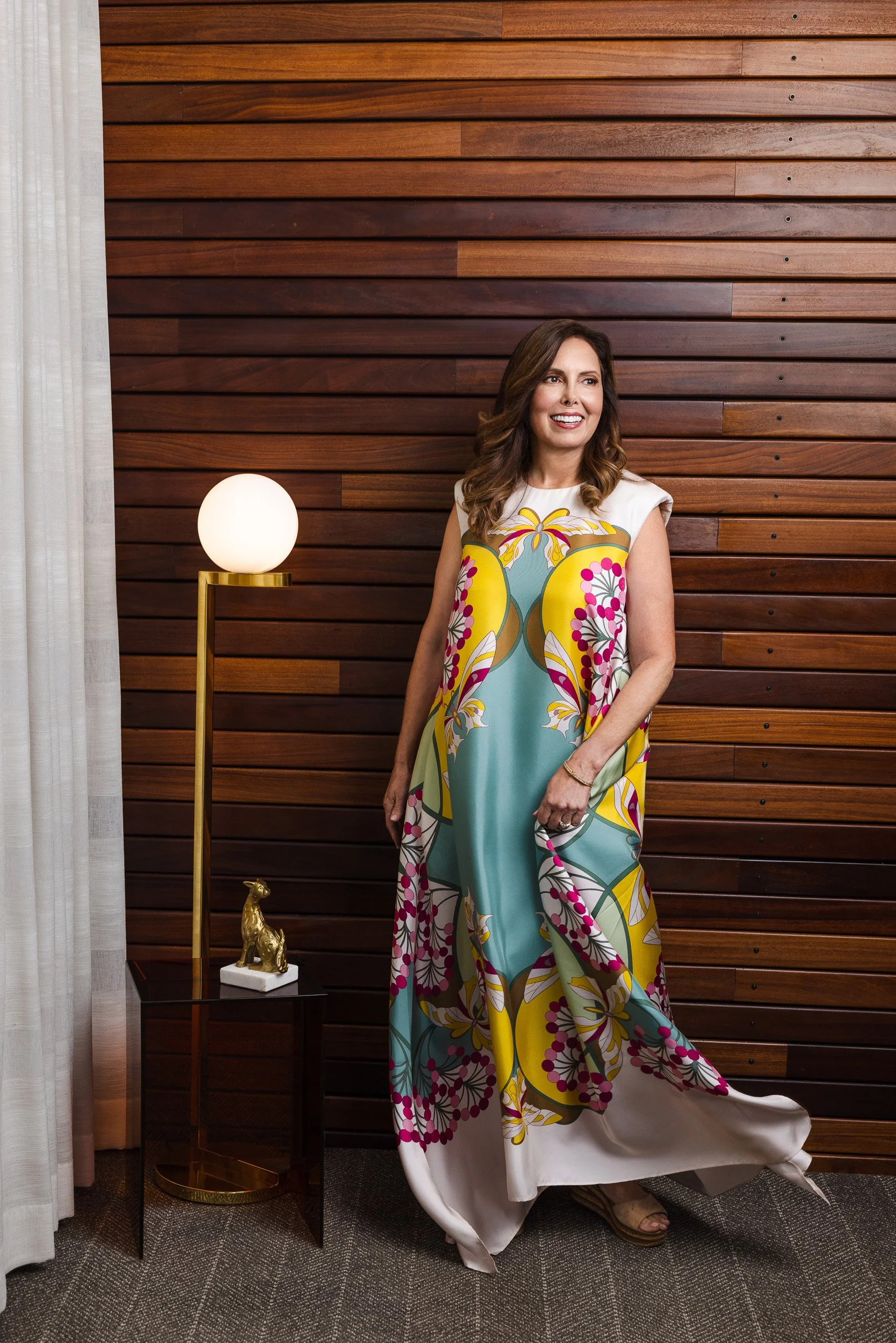 Renee Bates posing beside a brass floor lamp at the Fairlane Hotel, photographed by a Franklin TN editorial photographer."