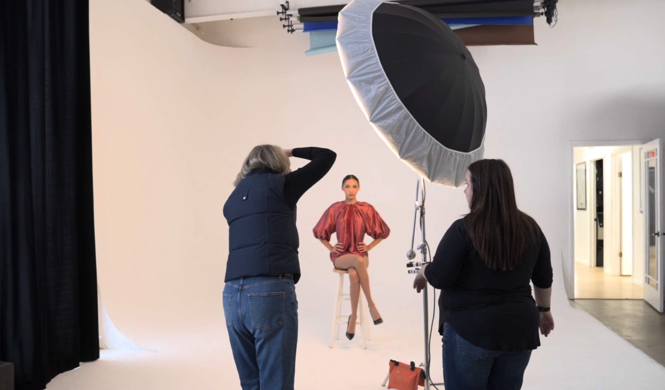 Behind the scenes of a two-light studio portrait setup during a Nashville photography workshop, with photographers learning lighting placement and direction