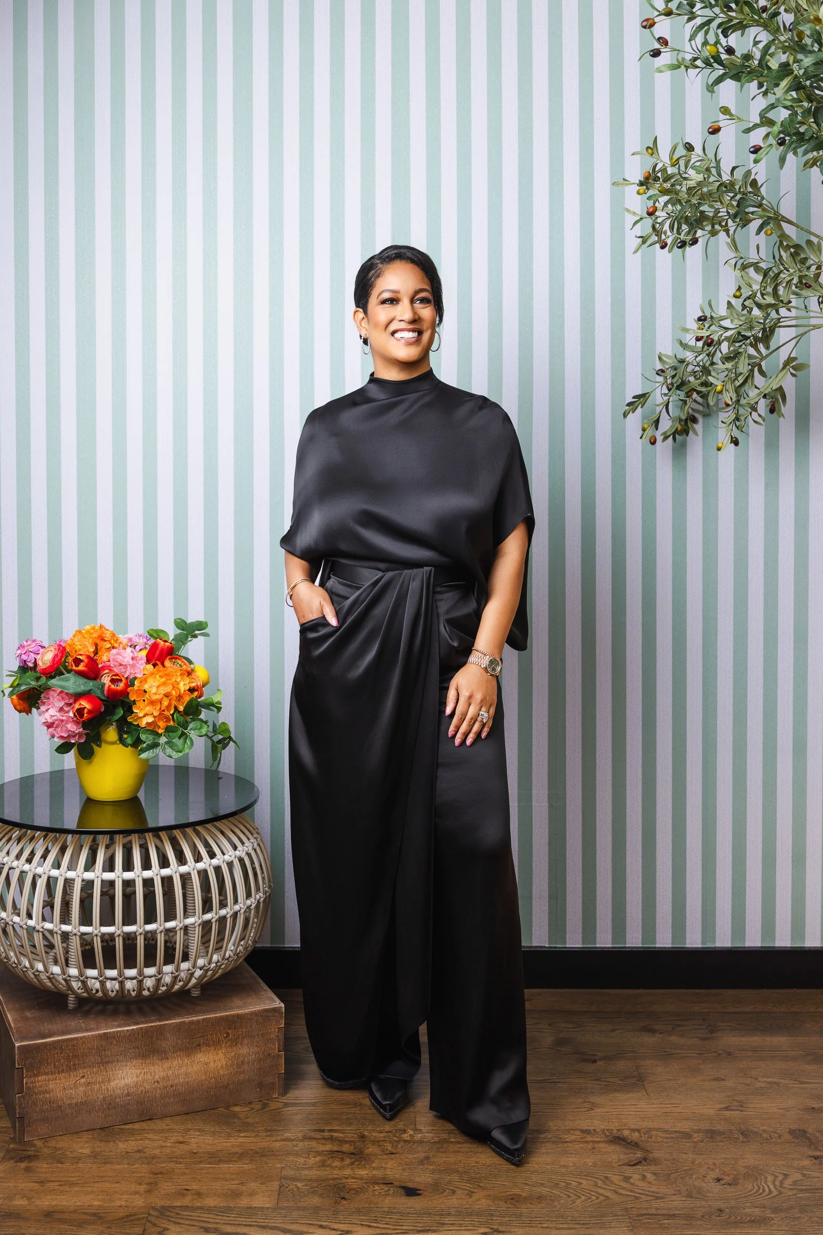 LaDonna Boyd smiling against the mint striped wallpaper at the Fairlane Hotel, photographed for nFocus Magazine's Model Behavior 2026."