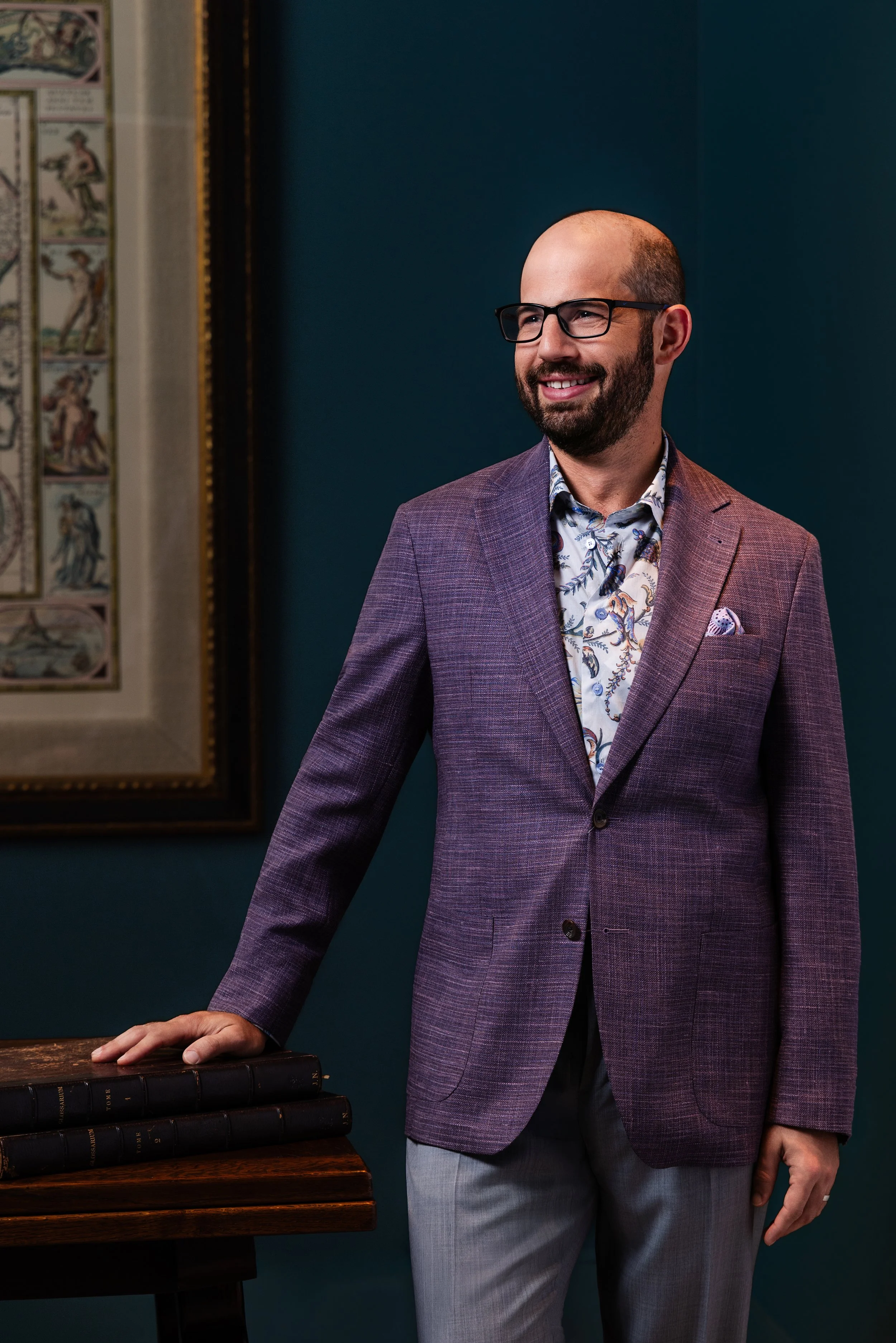 Portrait of Joel for the nFocus Fresh Faces editorial, leaning on a table in a teal-walled reading nook at The Manning in Nashville, photographed by Tausha Dickinson.