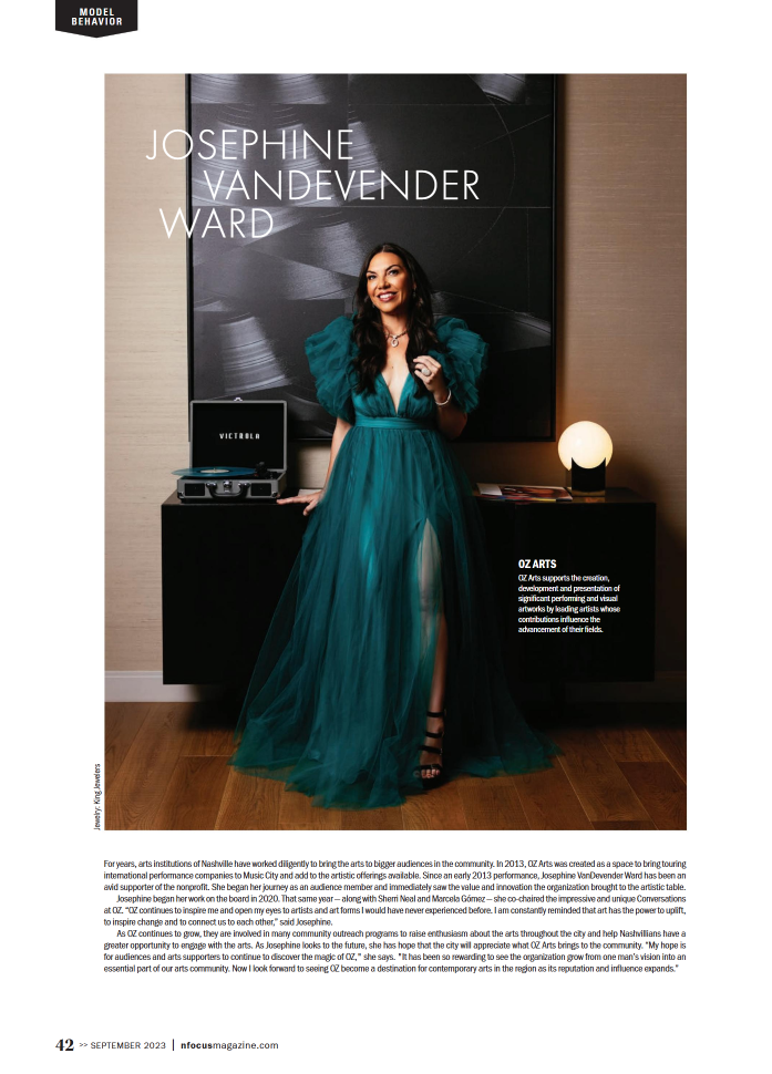 An editorial portrait featuring a model in a teal gown with voluminous sleeves, captured in a modern art-inspired setting. Nashville Fashion Photographer creating high-end editorial work that merges art and style.