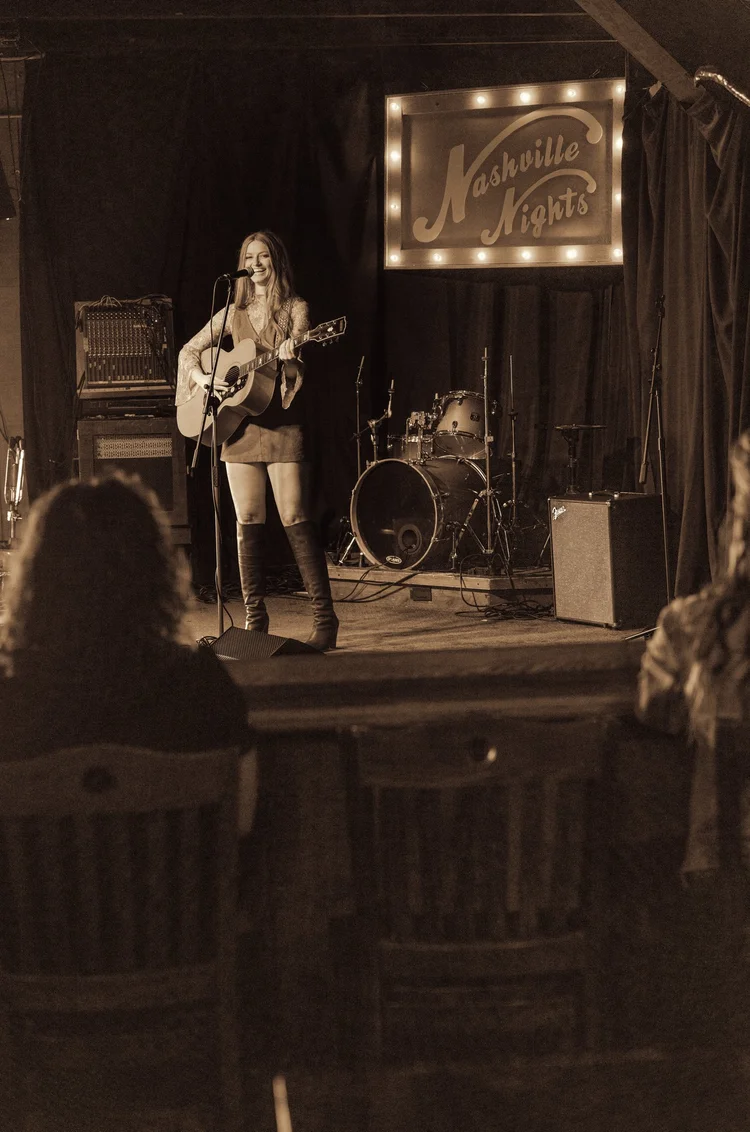 Mary Louise, the fictional music icon created for Tempo by Hilton Nashville, performing on stage, photographed by Nashville commercial photographer Tausha Dickinson