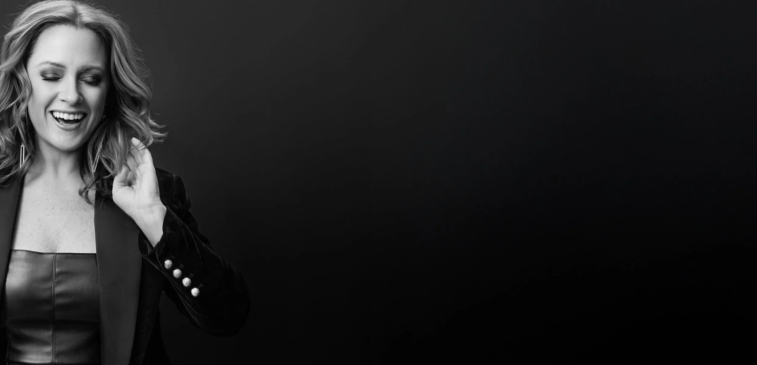 Black and white studio portrait created during a photography workshop focused on portrait lighting, expression, and posing