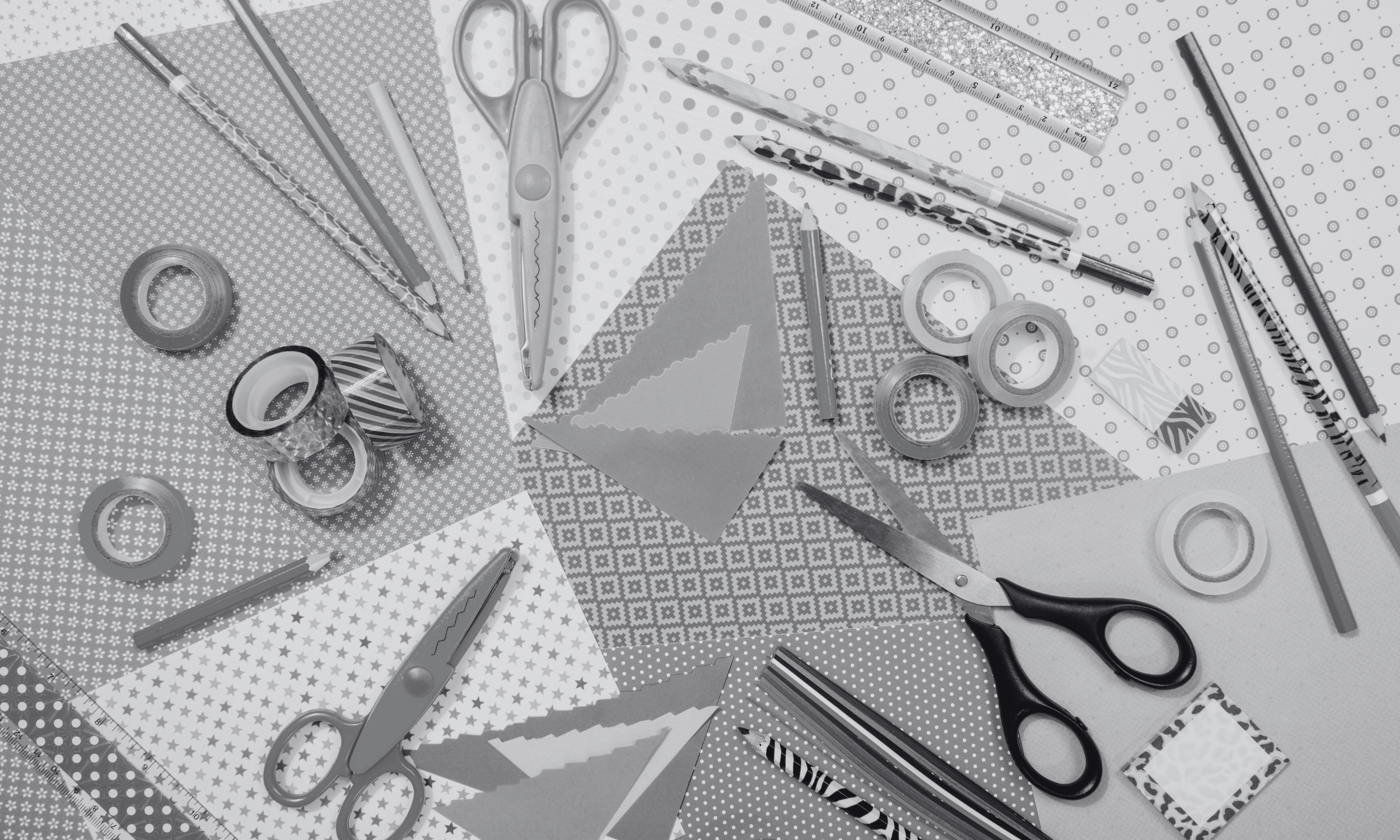 black and white image of paper, scissors and pencils for doing crafts
