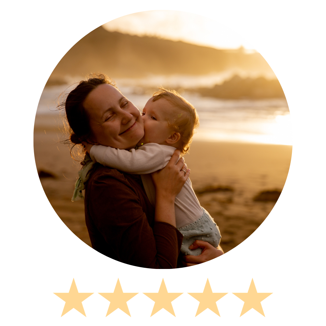 mother holds child on beach