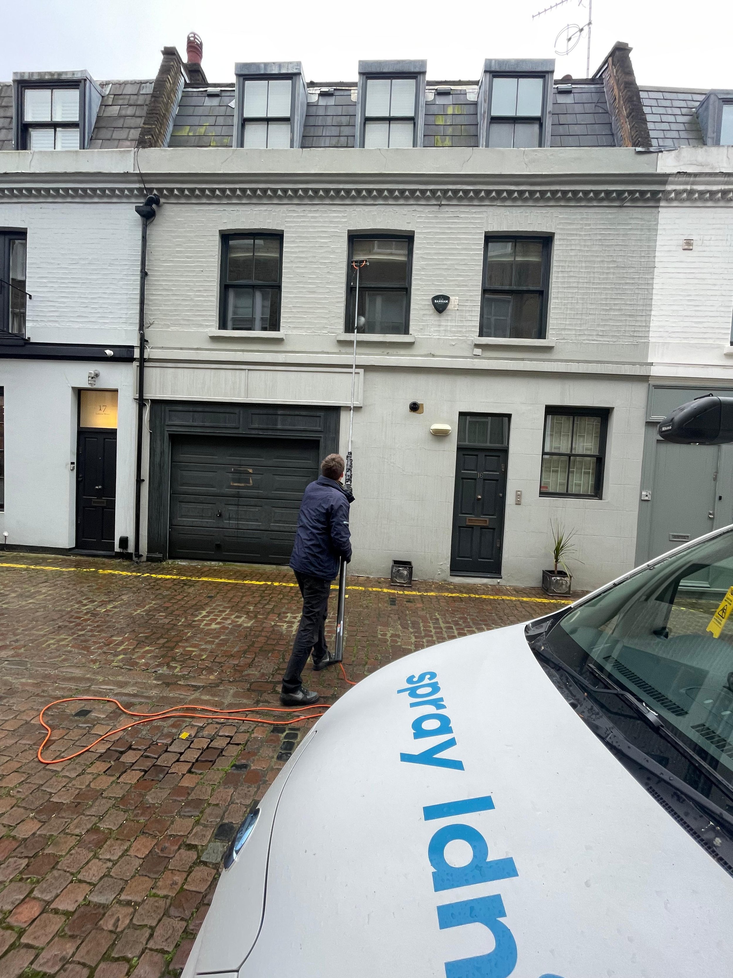 Window cleaning a mews house in Belgravia