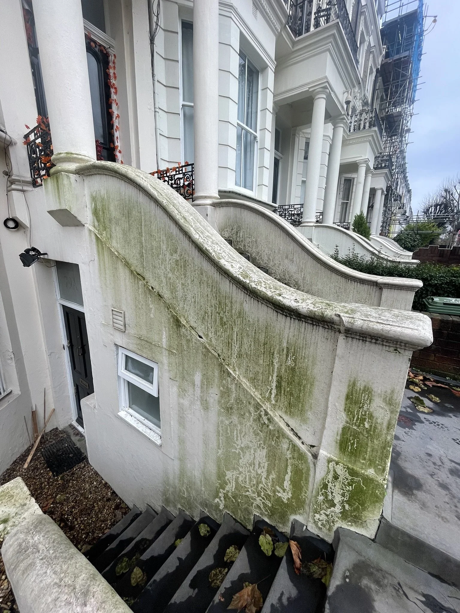 Algae painted masonry before cleaning