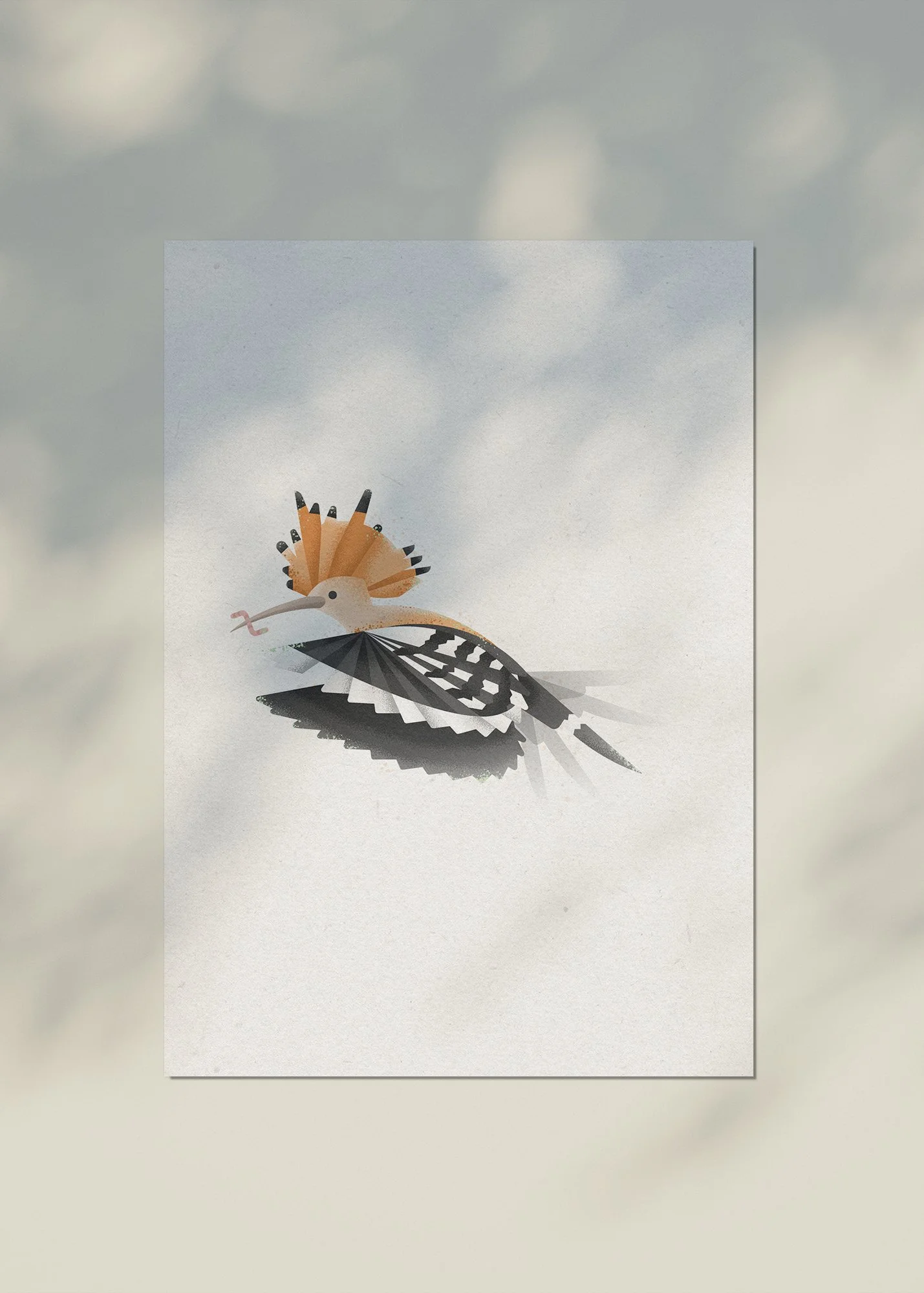 A cutout of a bird with a long beak, orange crest, and black-and-white patterned wings, shown against a cloudy sky.